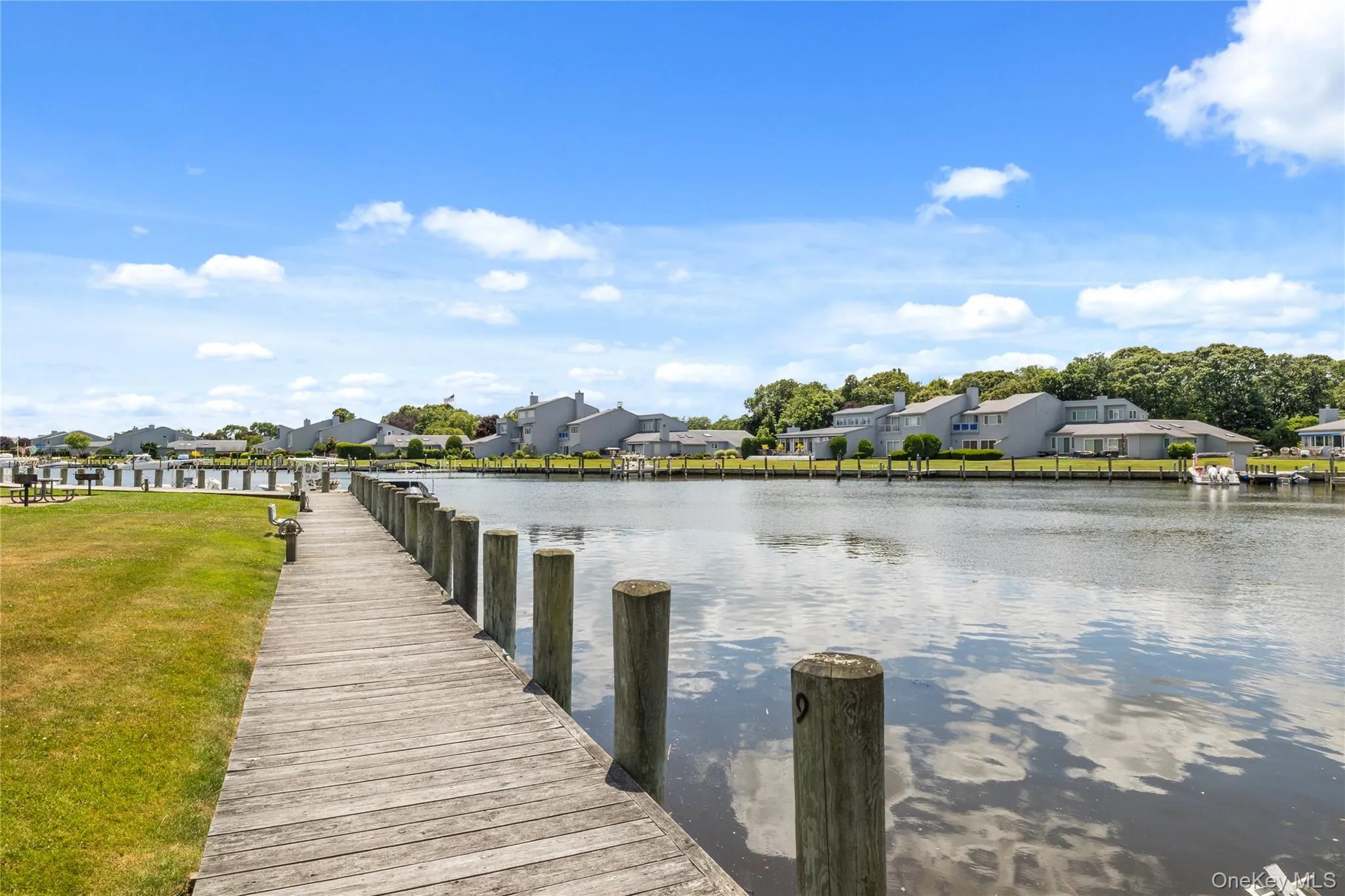 Dock area featuring a water view and a lawn Dock area featuring a water view and a lawn