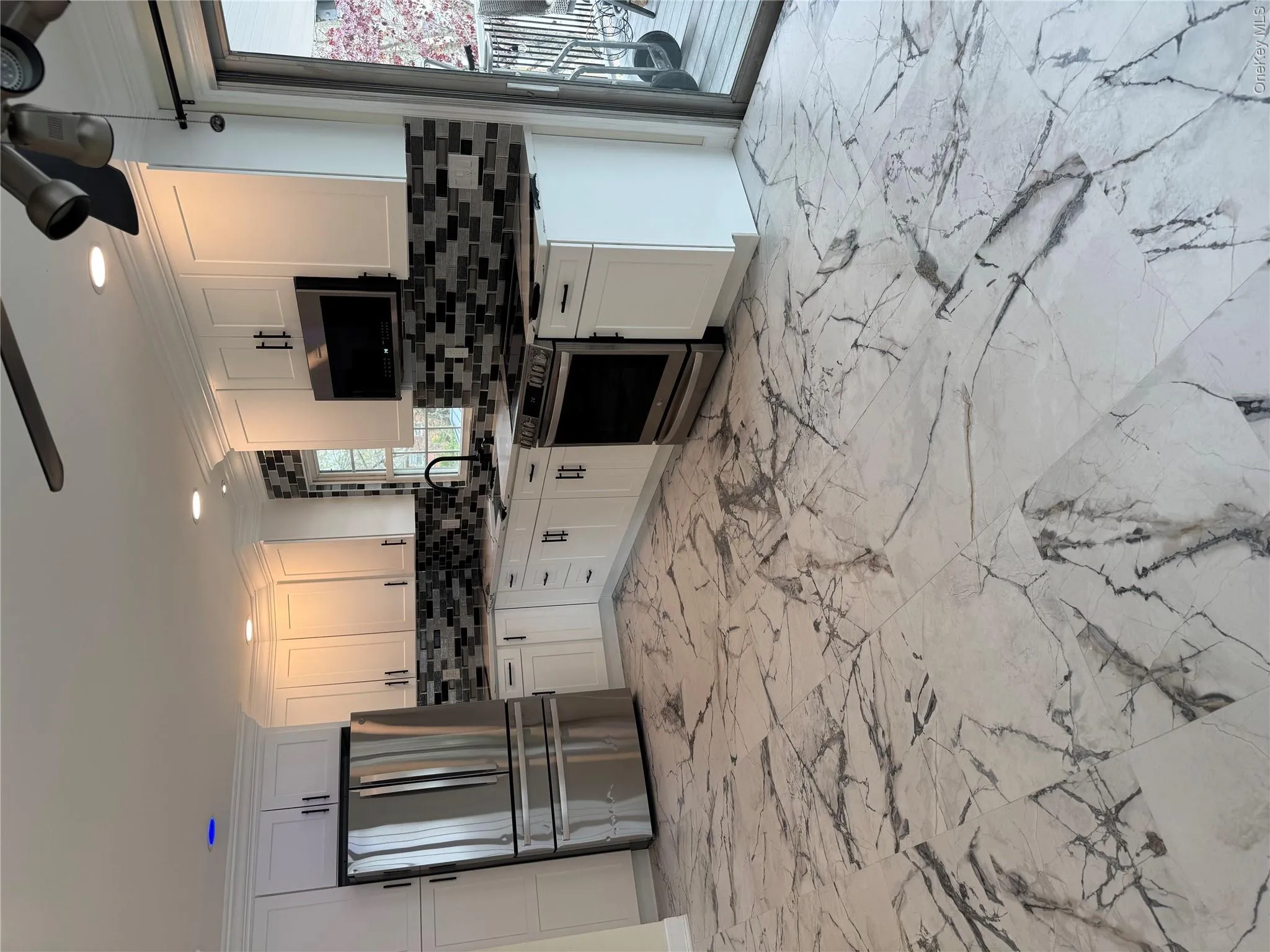 Modern kitchen with white cabinetry and stainless steel appliances Modern kitchen with white cabinetry and stainless steel appliances