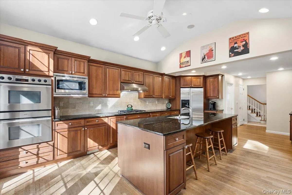 Another view of the kitchen with double ovens, ample cabinetry and pantry storage. Another view of the kitchen with double ovens, ample cabinetry and pantry storage.