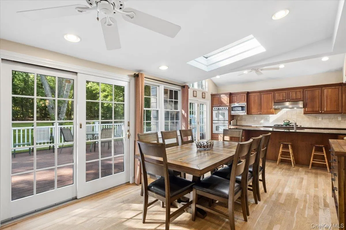 Enjoy dining in the kitchen/family room with views out to the deck and beautifully landscaped property Enjoy dining in the kitchen/family room with views out to the deck and beautifully landscaped property