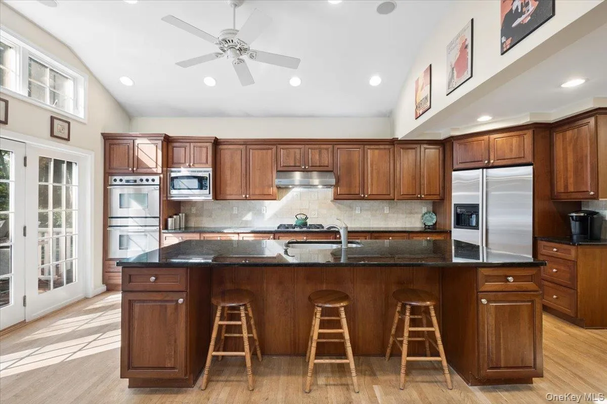 Easy access to the expansive deck from the kitchen for bbqs overlooking the beautiful 0.79 acre park-like yard. Easy access to the expansive deck from the kitchen for bbqs overlooking the beautiful 0.79 acre park-like yard.