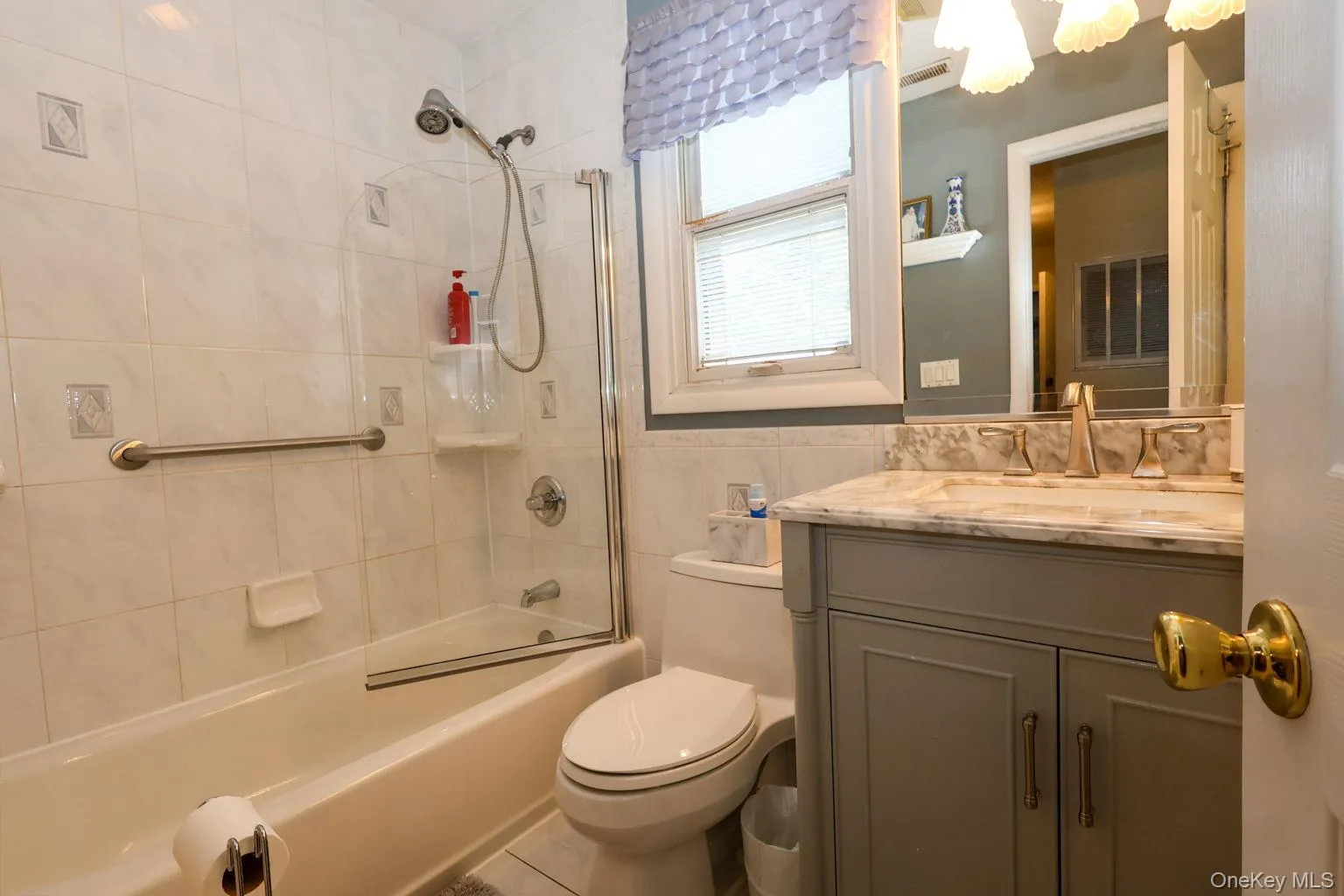 Elegant and stylish tiled Bathroom, shower/tub, European shower door, updated vanity Elegant and stylish tiled Bathroom, shower/tub, European shower door, updated vanity