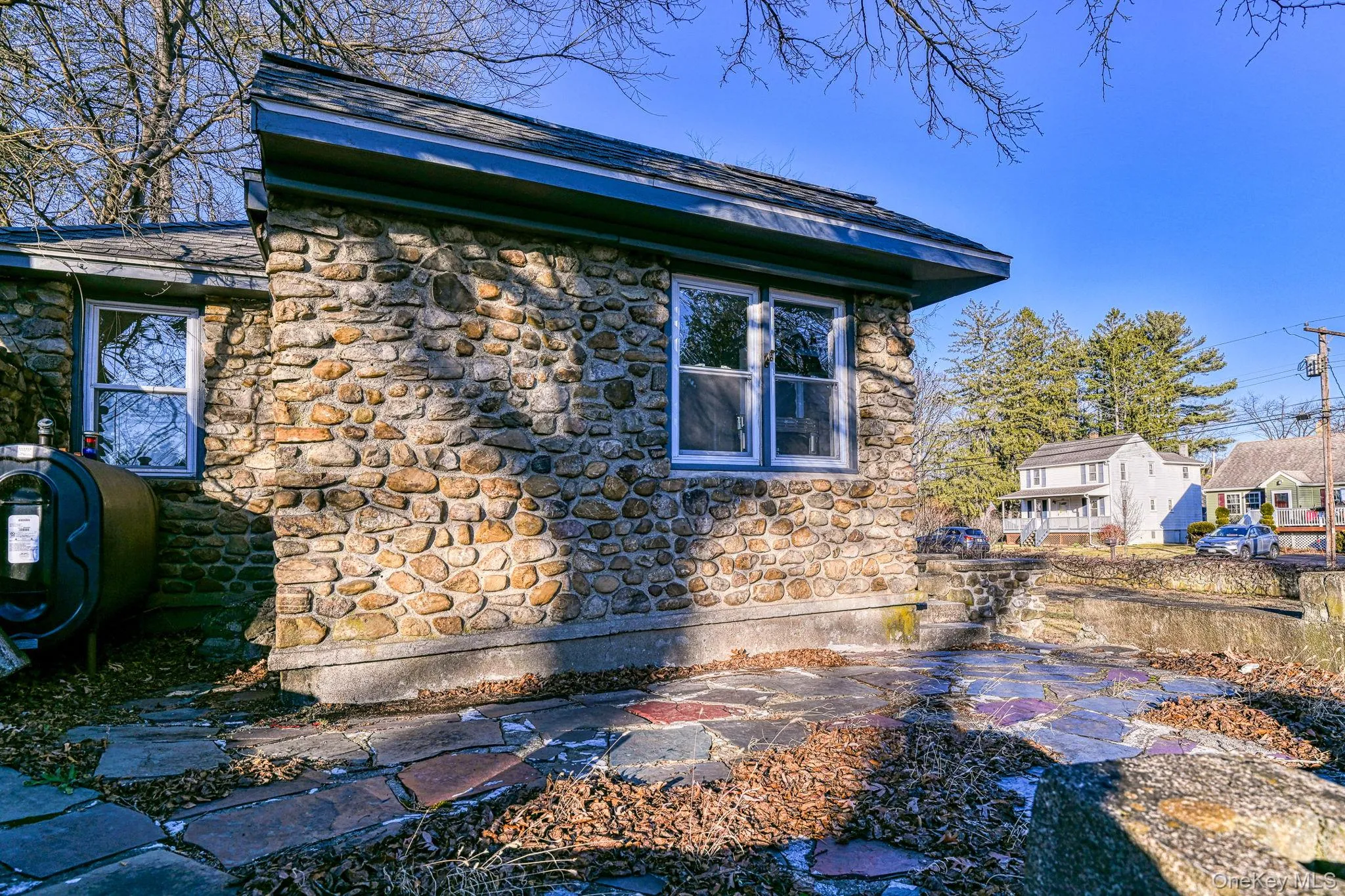 View of side of home featuring a patio area View of side of home featuring a patio area