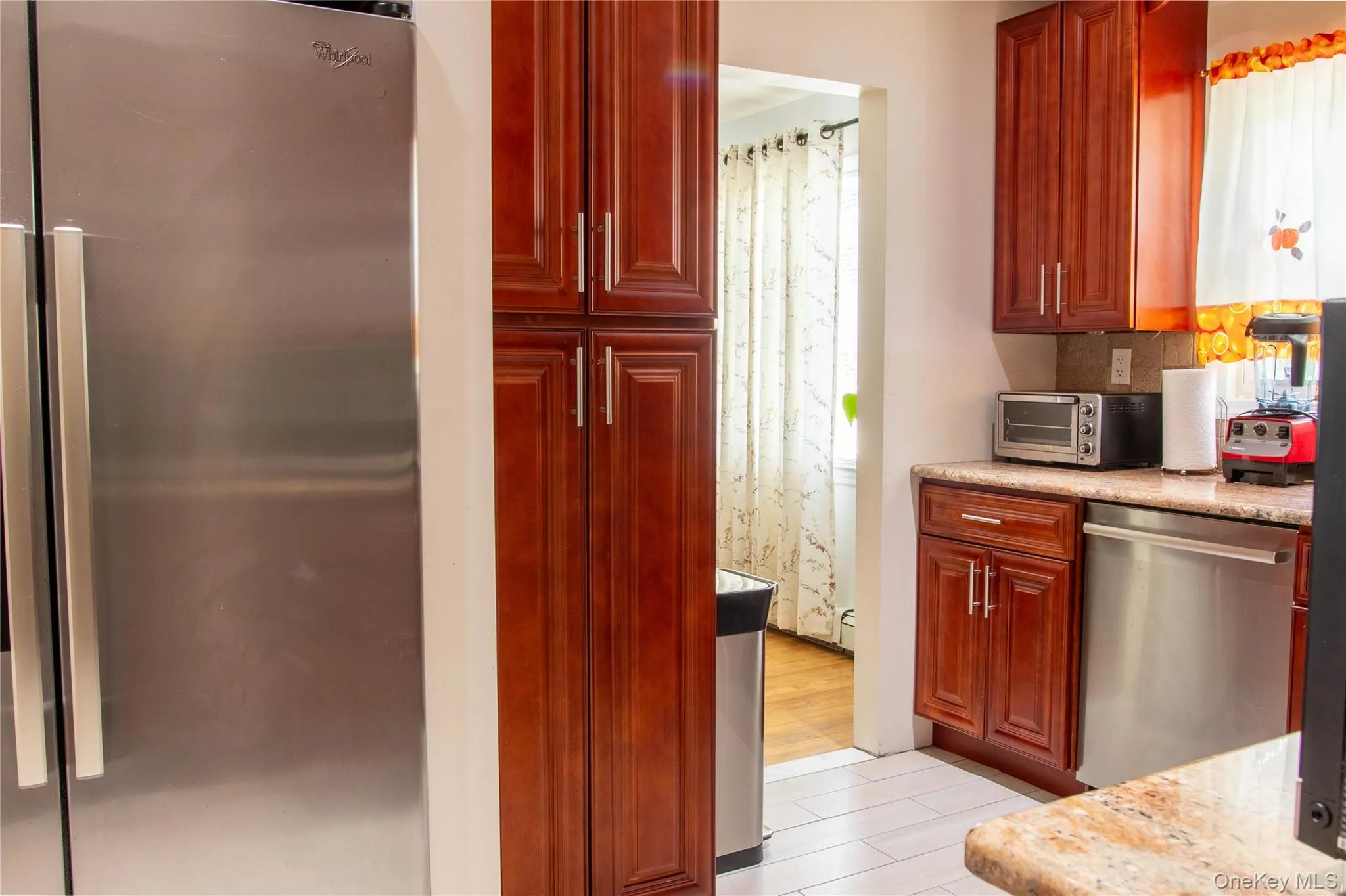 Kitchen with Stainless Steel Appliances, Updated Cabinets, Counters and Floor View from Stairs Kitchen with Stainless Steel Appliances, Updated Cabinets, Counters and Floor View from Stairs