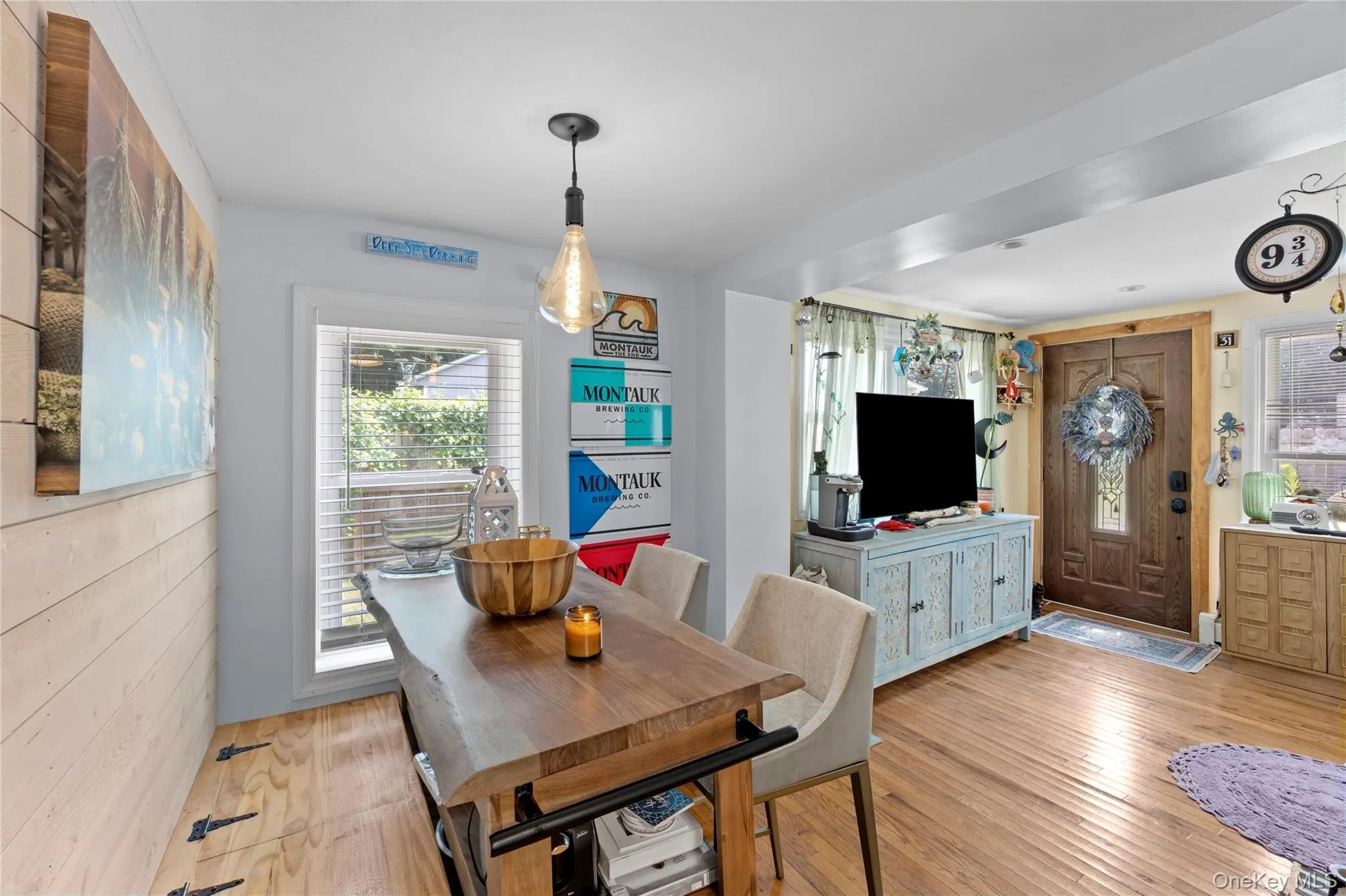 Hardwood flooring throughout the open living area, featuring a decorative front entry door with a frosted glass insert Hardwood flooring throughout the open living area, featuring a decorative front entry door with a frosted glass insert