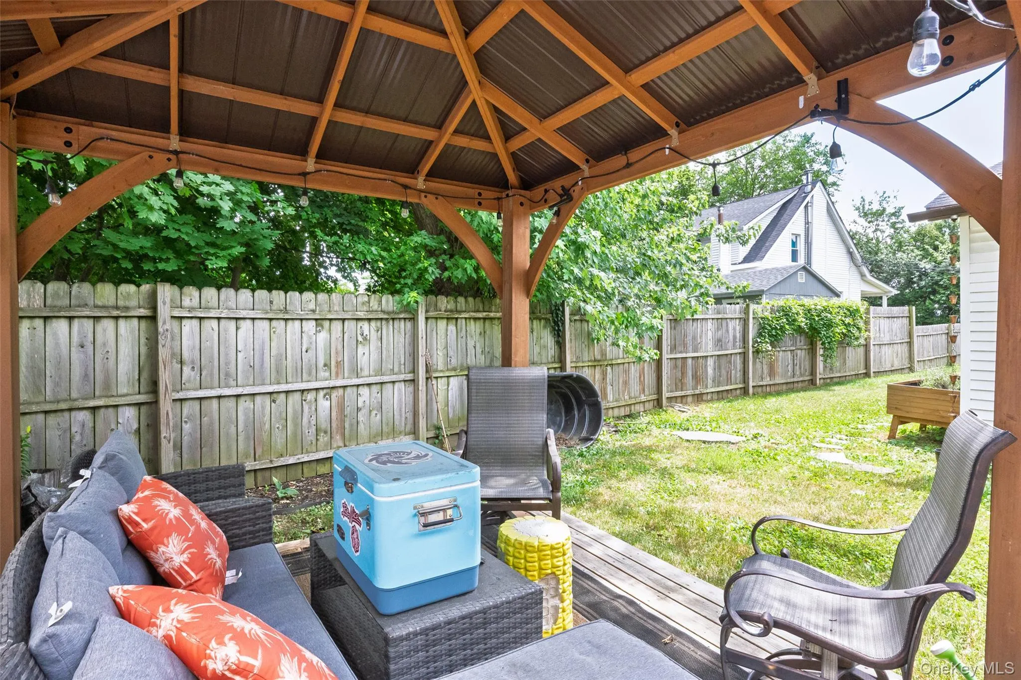 Outdoor gazebo featuring a corrugated metal roof and exposed wood beams Outdoor gazebo featuring a corrugated metal roof and exposed wood beams