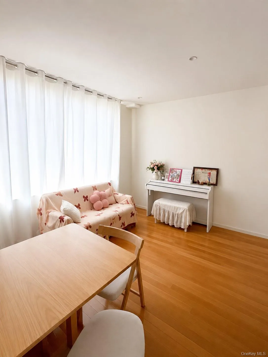 Light-filled room featuring wood-finish flooring, recessed lighting, and expansive windows Light-filled room featuring wood-finish flooring, recessed lighting, and expansive windows
