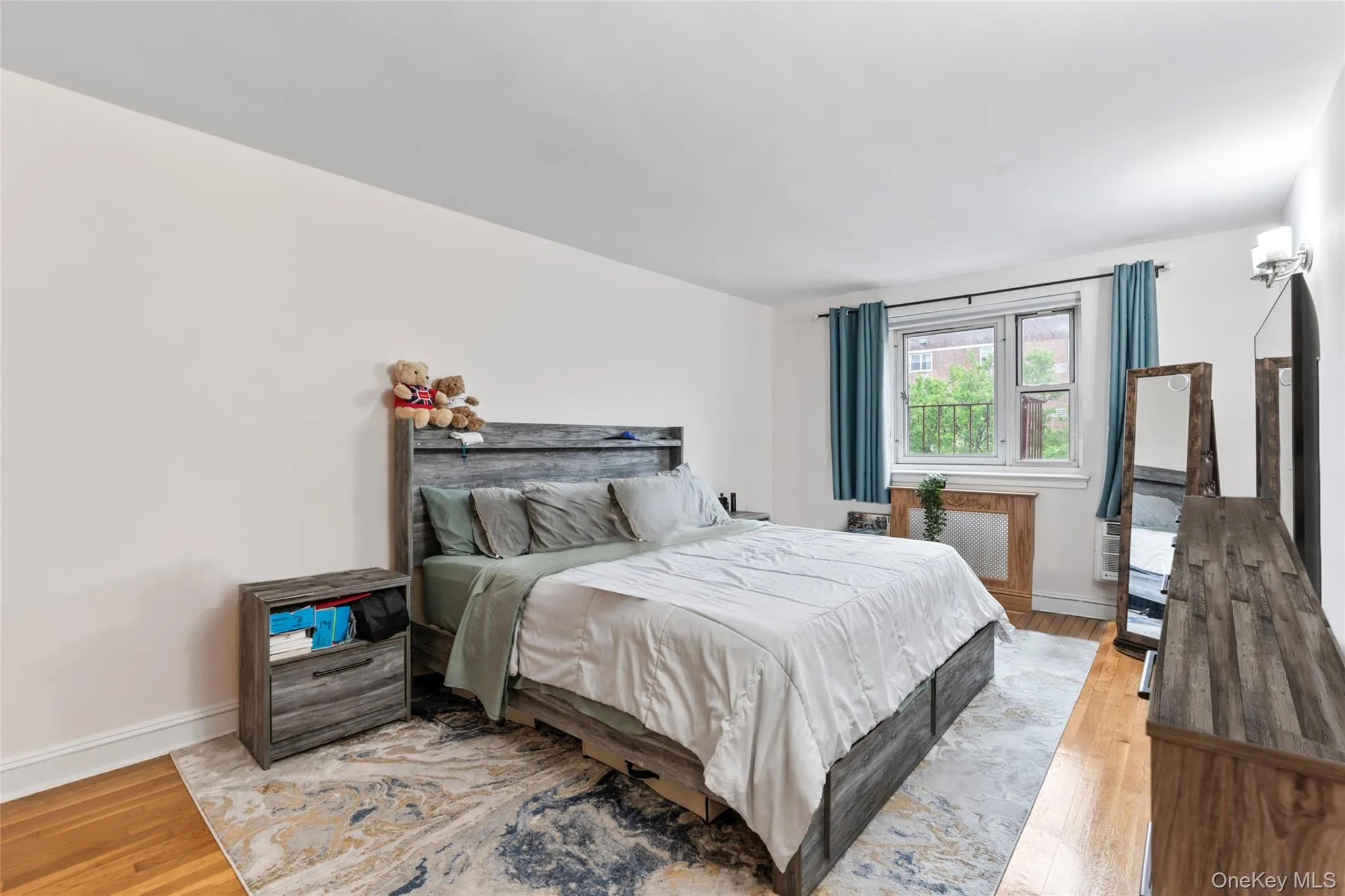 Bedroom with light wood-type flooring and baseboards Bedroom with light wood-type flooring and baseboards