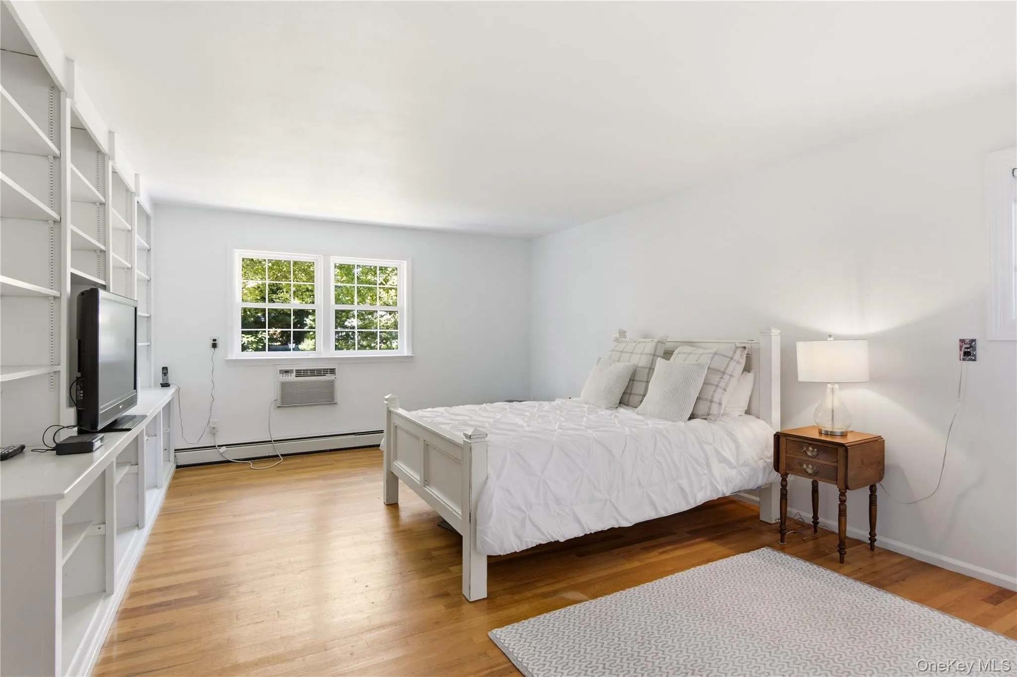 Primary suite with hardwood flooring Primary suite with hardwood flooring