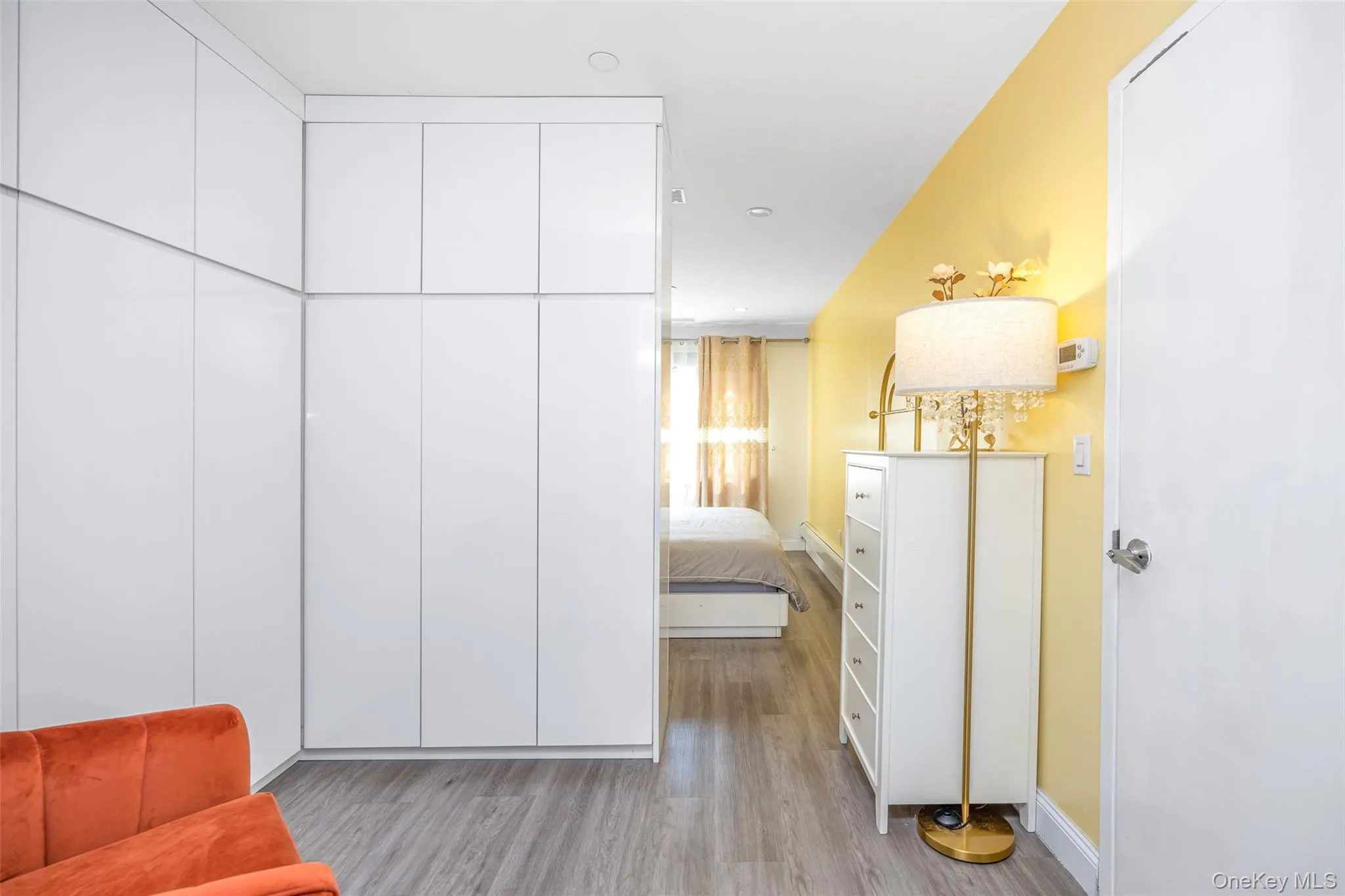 Bedroom with light wood finished floors and baseboards Bedroom with light wood finished floors and baseboards