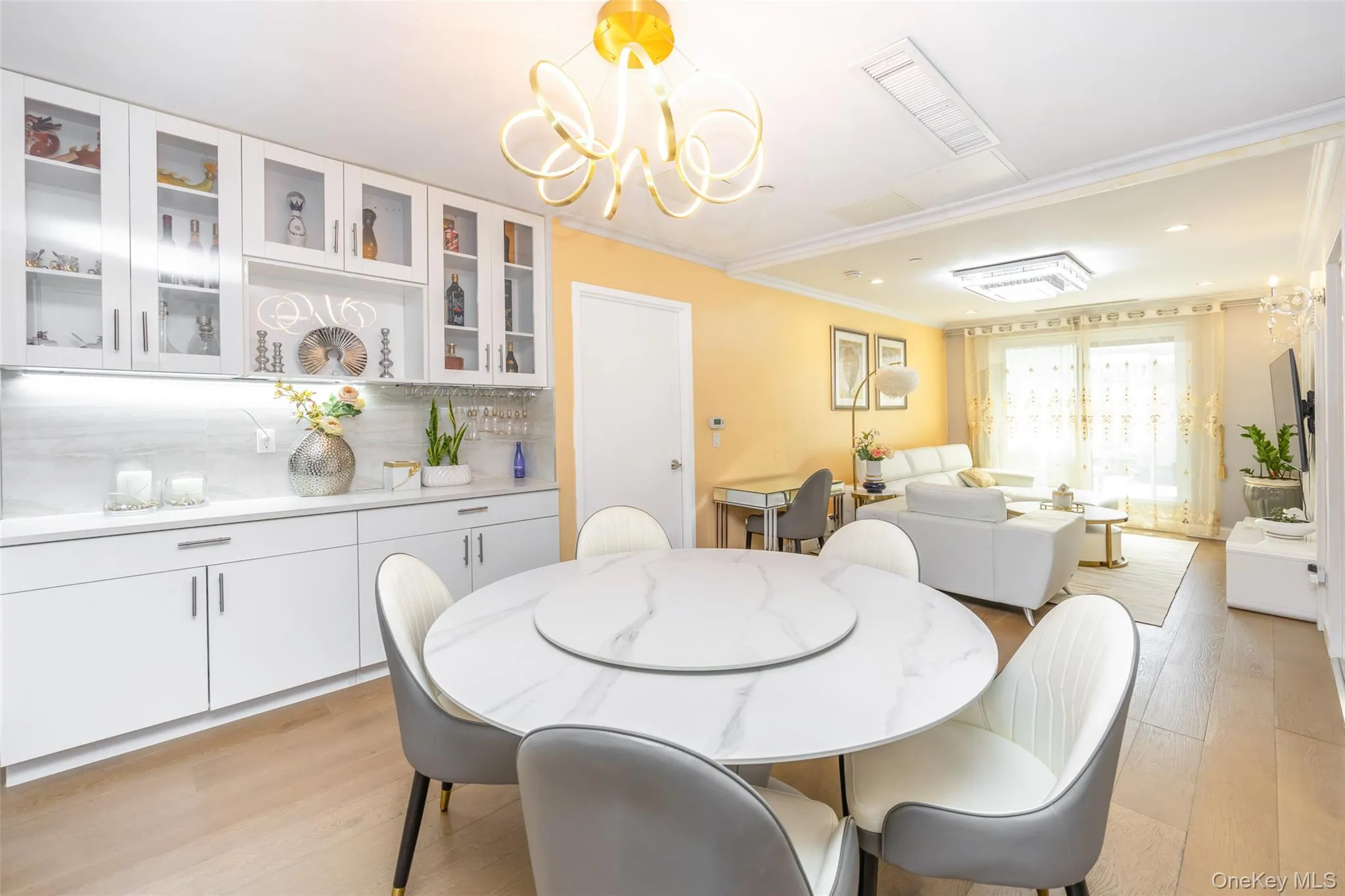 Dining area featuring light wood-style floors, a chandelier, crown molding, and recessed lighting Dining area featuring light wood-style floors, a chandelier, crown molding, and recessed lighting
