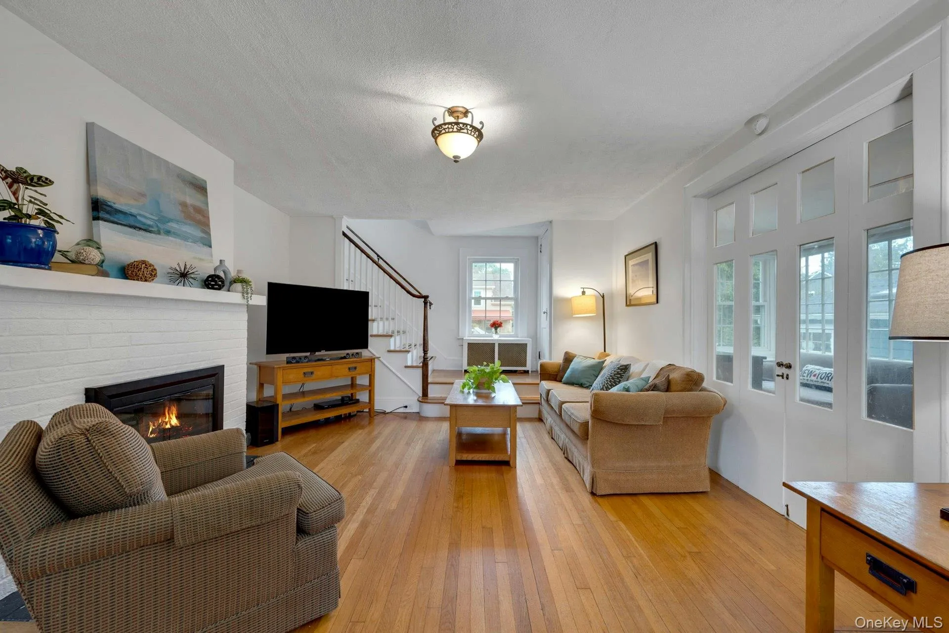 Living room with glass doors to sun room Living room with glass doors to sun room