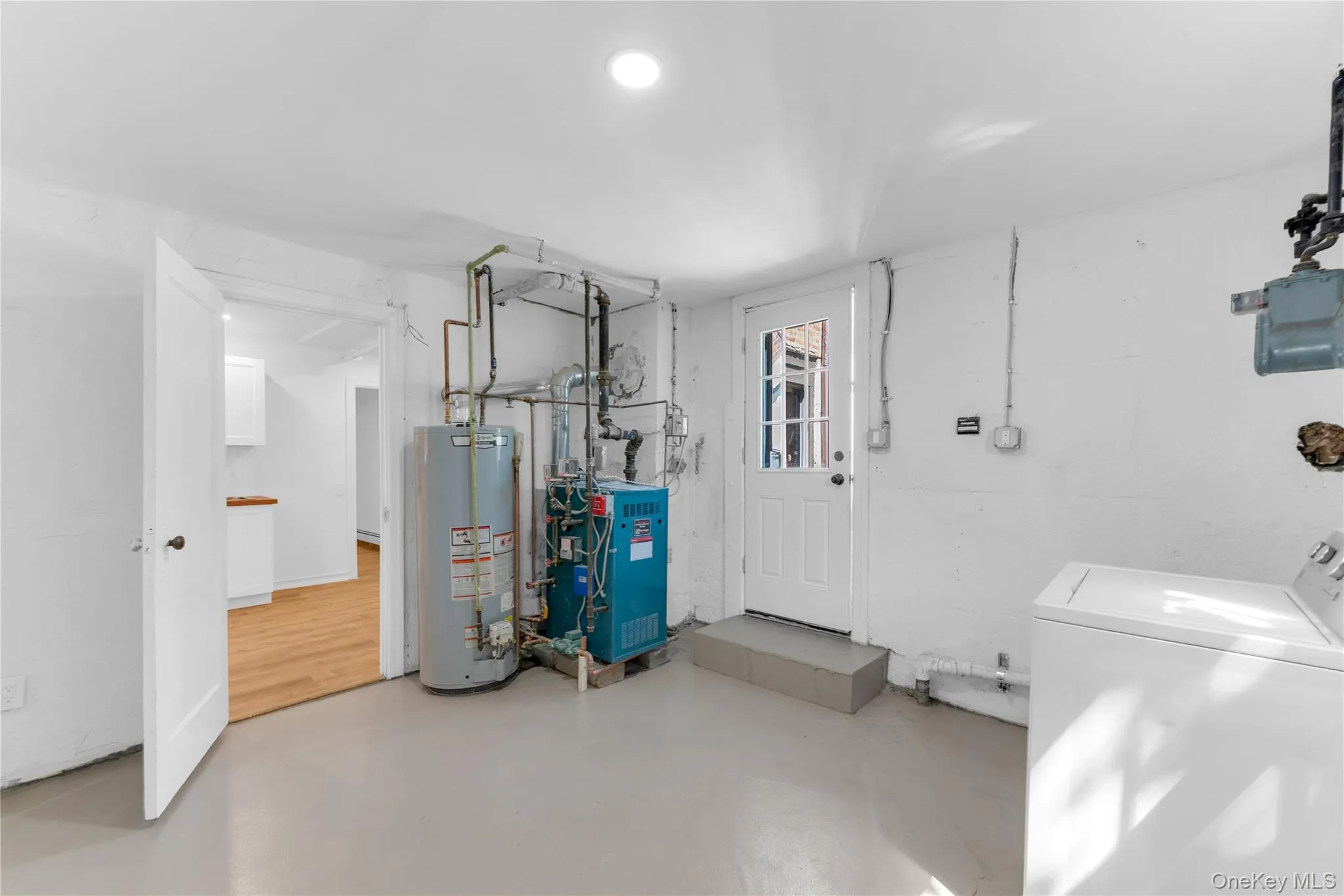 Utility room located on lower level. Door not pictured leads to garage and driveway. Utility room located on lower level. Door not pictured leads to garage and driveway.
