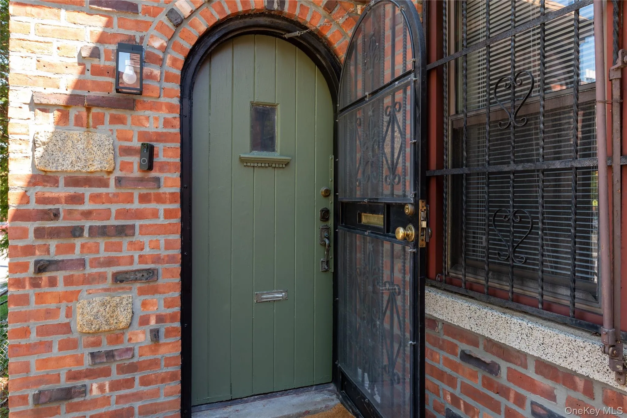 Front door from outside against brick facade Front door from outside against brick facade