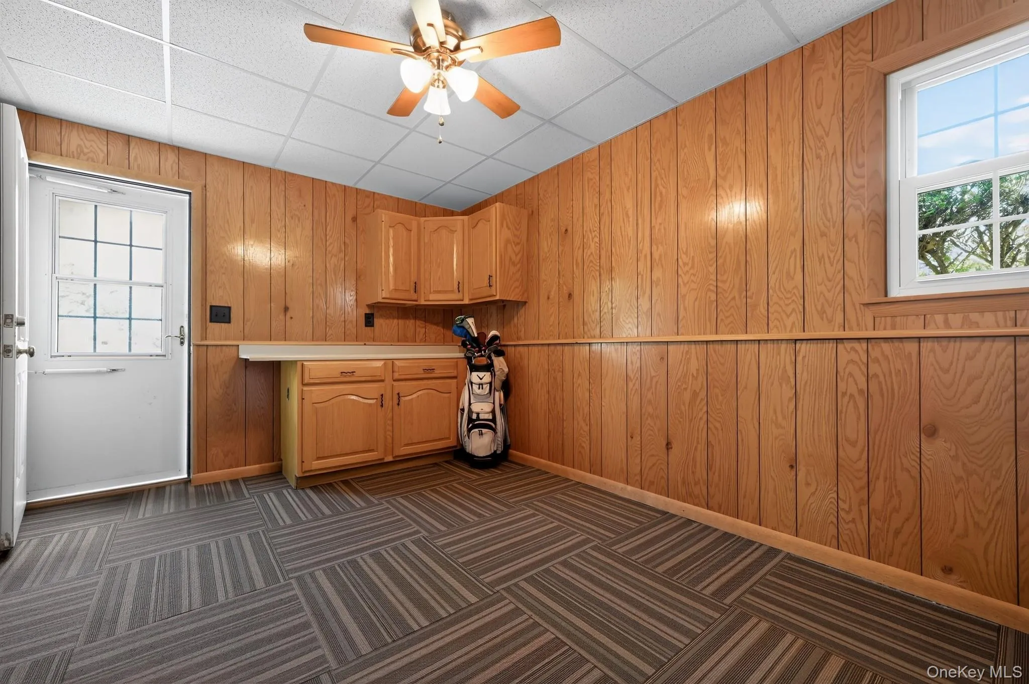 with door out to driveway, built in cabinets and countertop for folding with door out to driveway, built in cabinets and countertop for folding