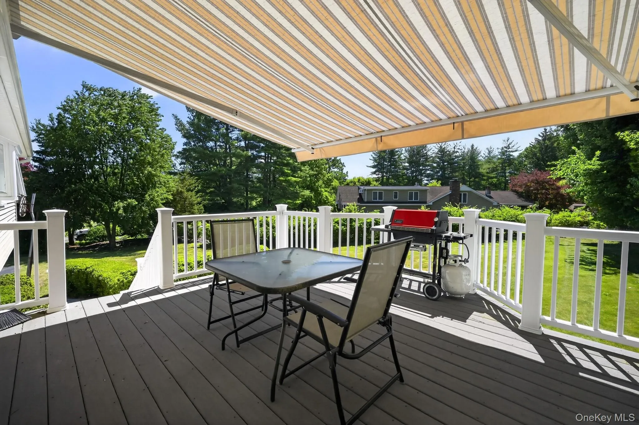 Spacious deck featuring an electric retractable awing, vinyl railings & Trex plank decking Spacious deck featuring an electric retractable awing, vinyl railings & Trex plank decking