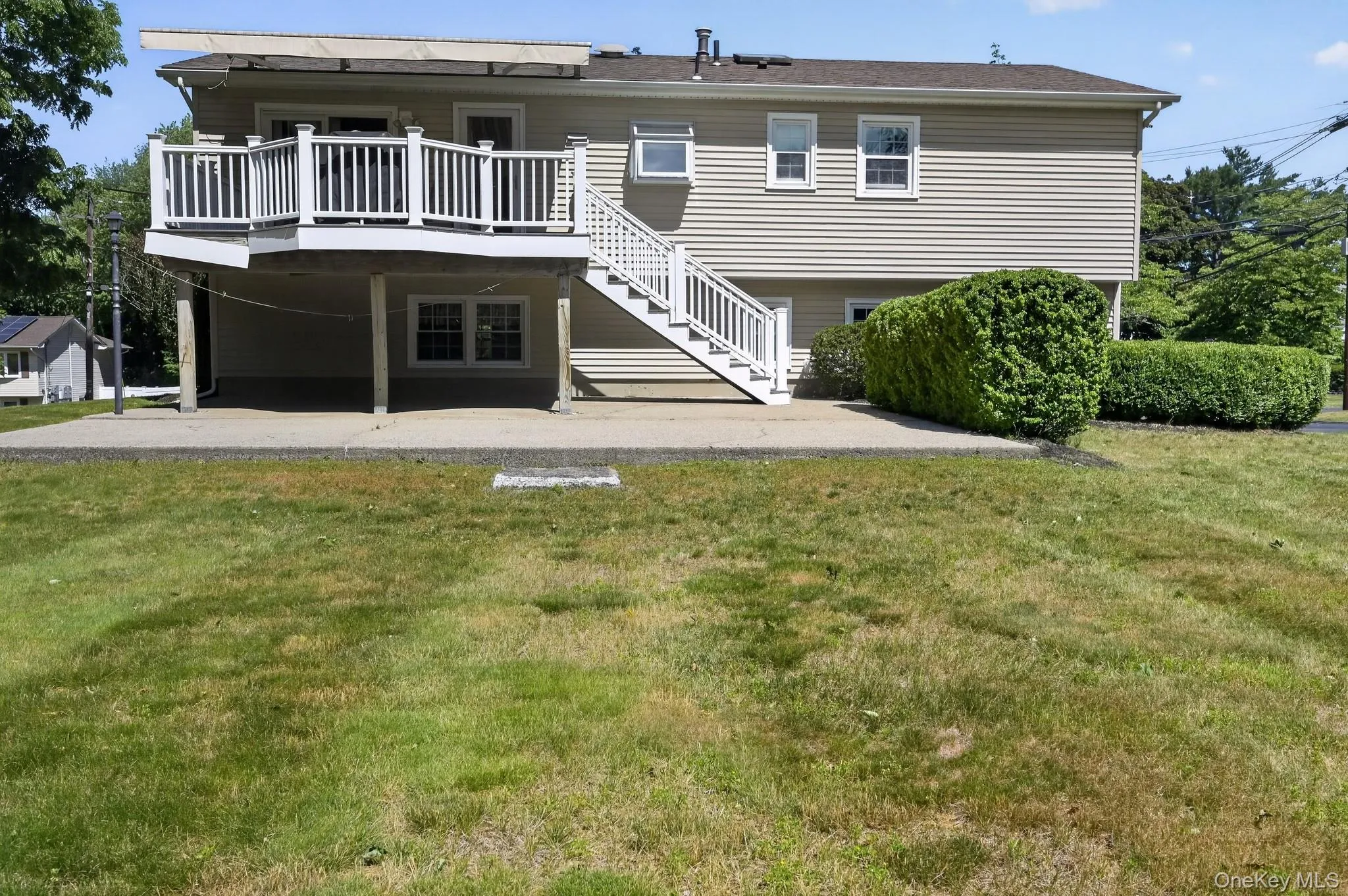 with concrete patio and grass area with concrete patio and grass area