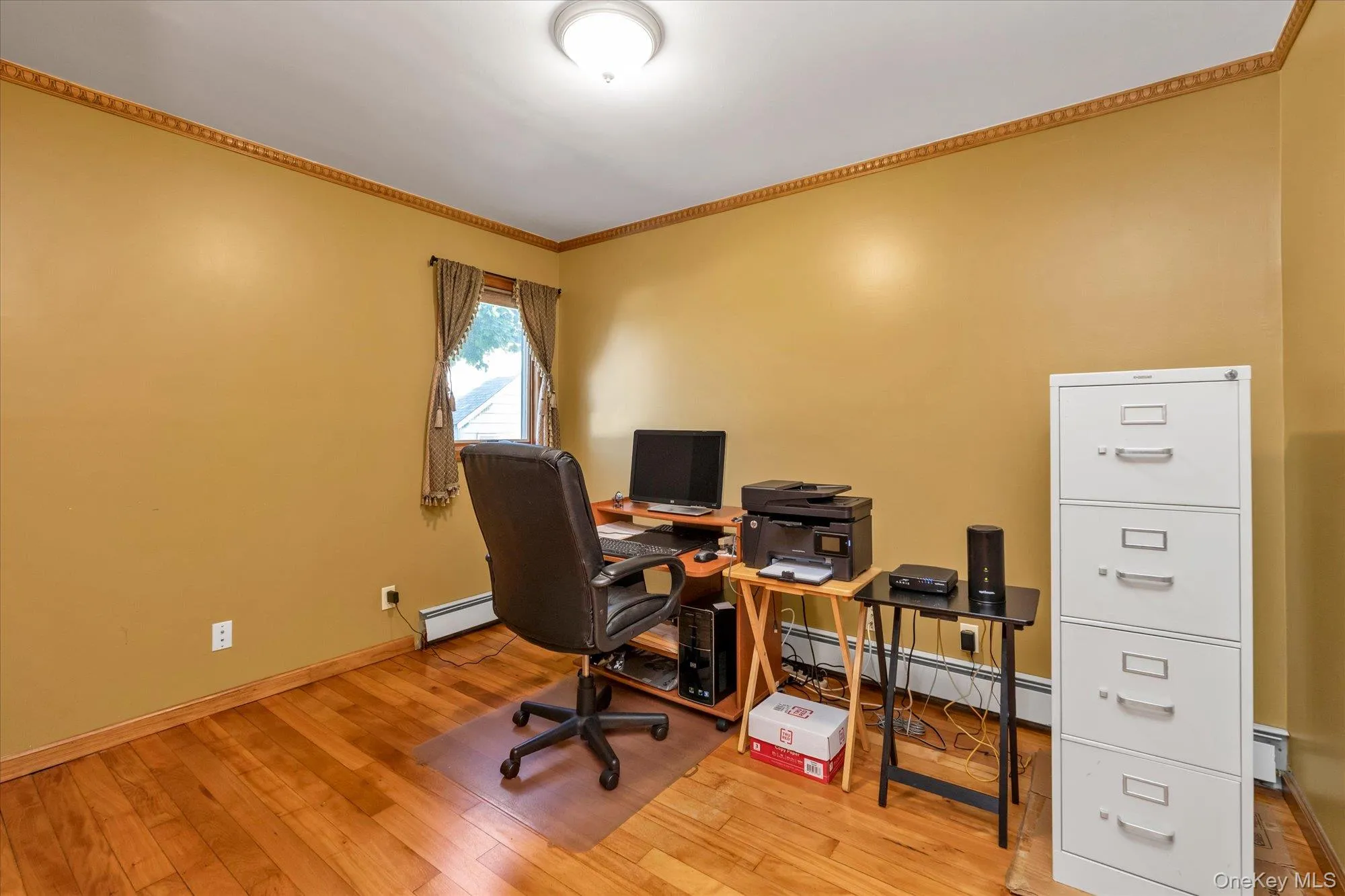 Room featuring wood-finish flooring, a single window, and crown molding Room featuring wood-finish flooring, a single window, and crown molding