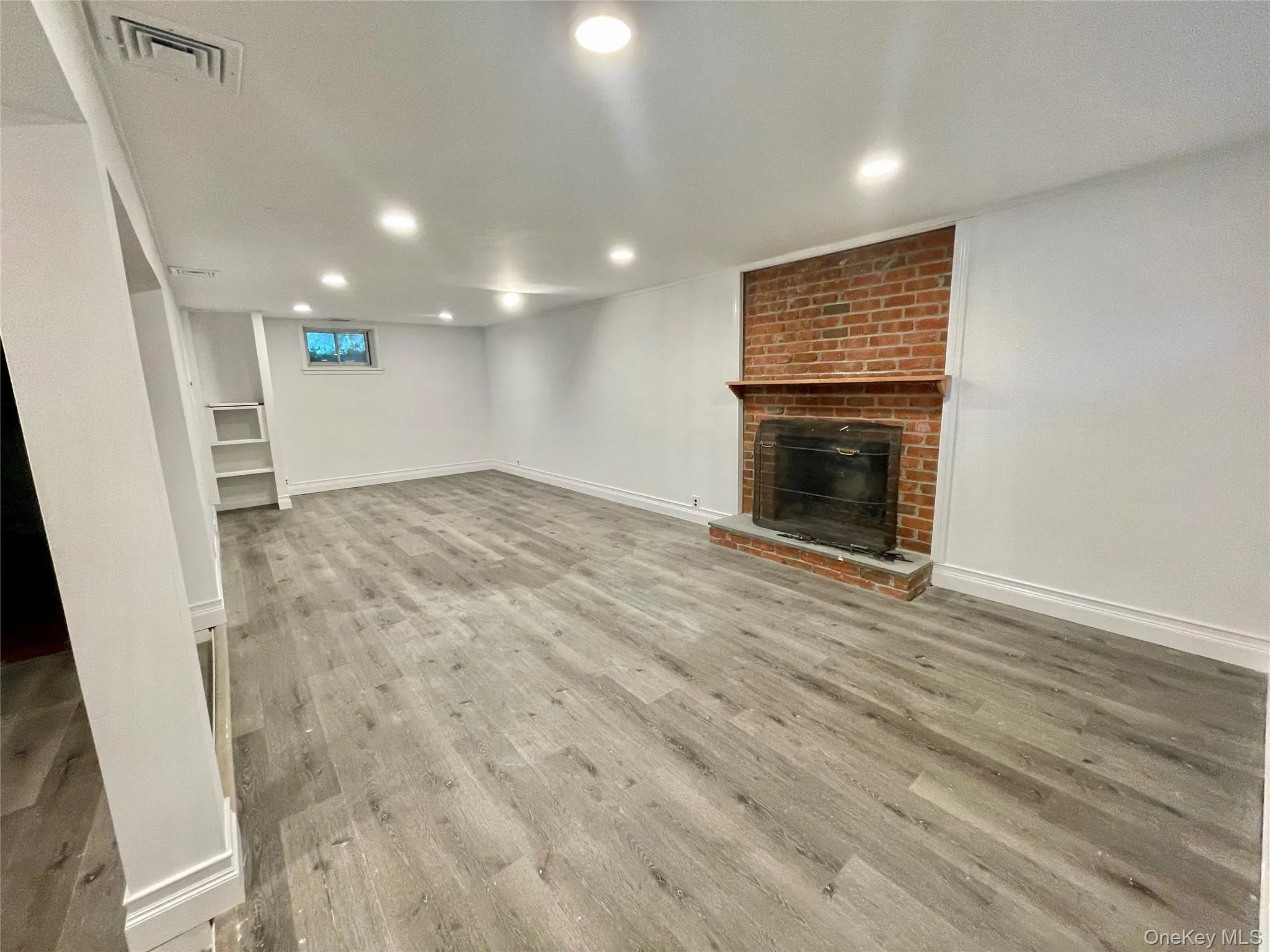 Finished lower level recreation room with fireplace. Laundry room and storage room Finished lower level recreation room with fireplace. Laundry room and storage room