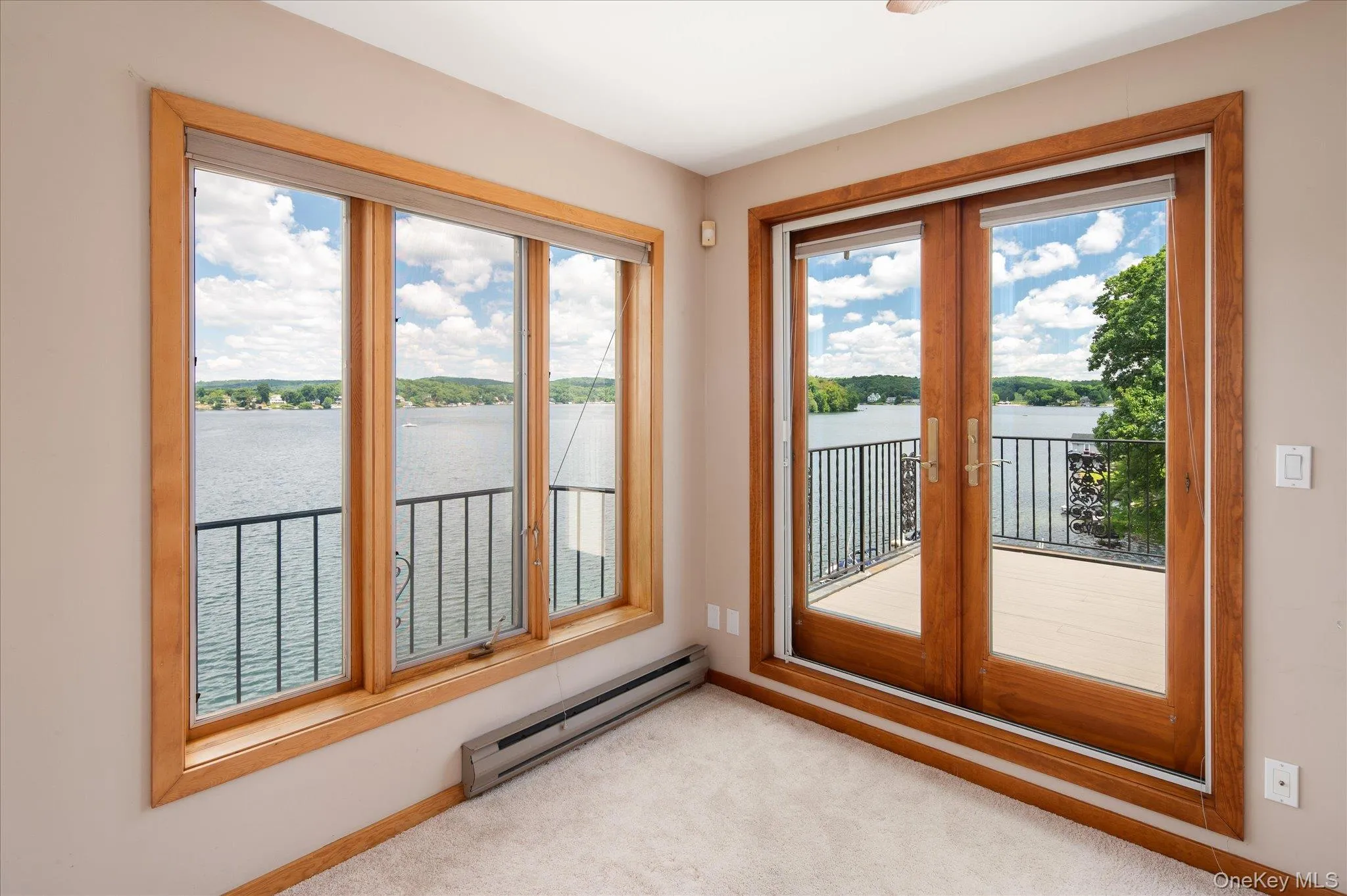 French doors open onto a private deck with sweeping Lake Mahopac views from this upper level bedroom French doors open onto a private deck with sweeping Lake Mahopac views from this upper level bedroom