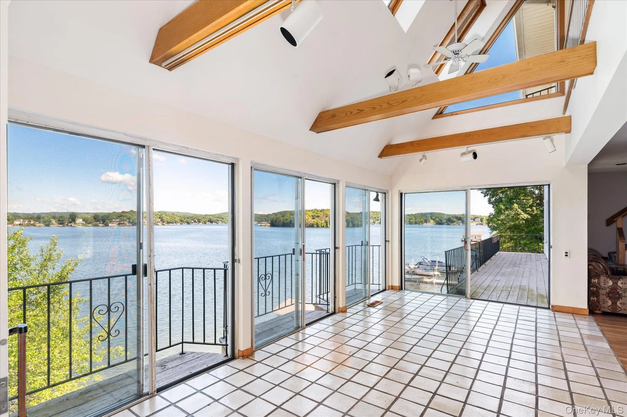 Floor-to-ceiling glass frames an unobstructed panorama of open water on Lake Mahopac Floor-to-ceiling glass frames an unobstructed panorama of open water on Lake Mahopac