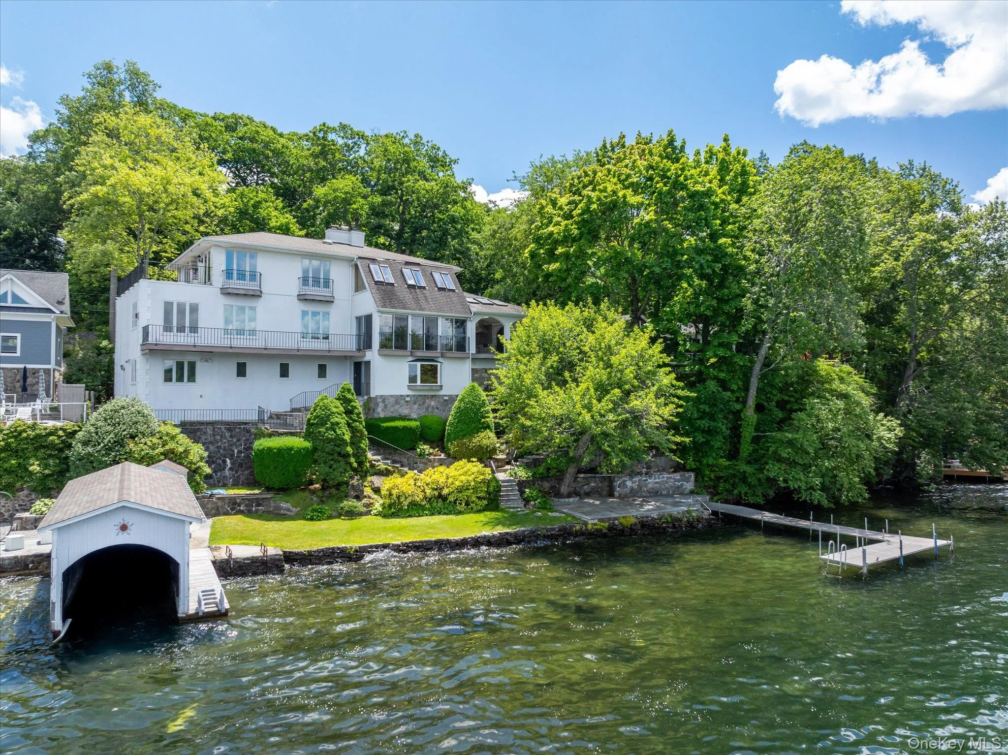Waterfront living on Lake Mahopac with a private boathouse, dock, and west-facing sunset views Waterfront living on Lake Mahopac with a private boathouse, dock, and west-facing sunset views