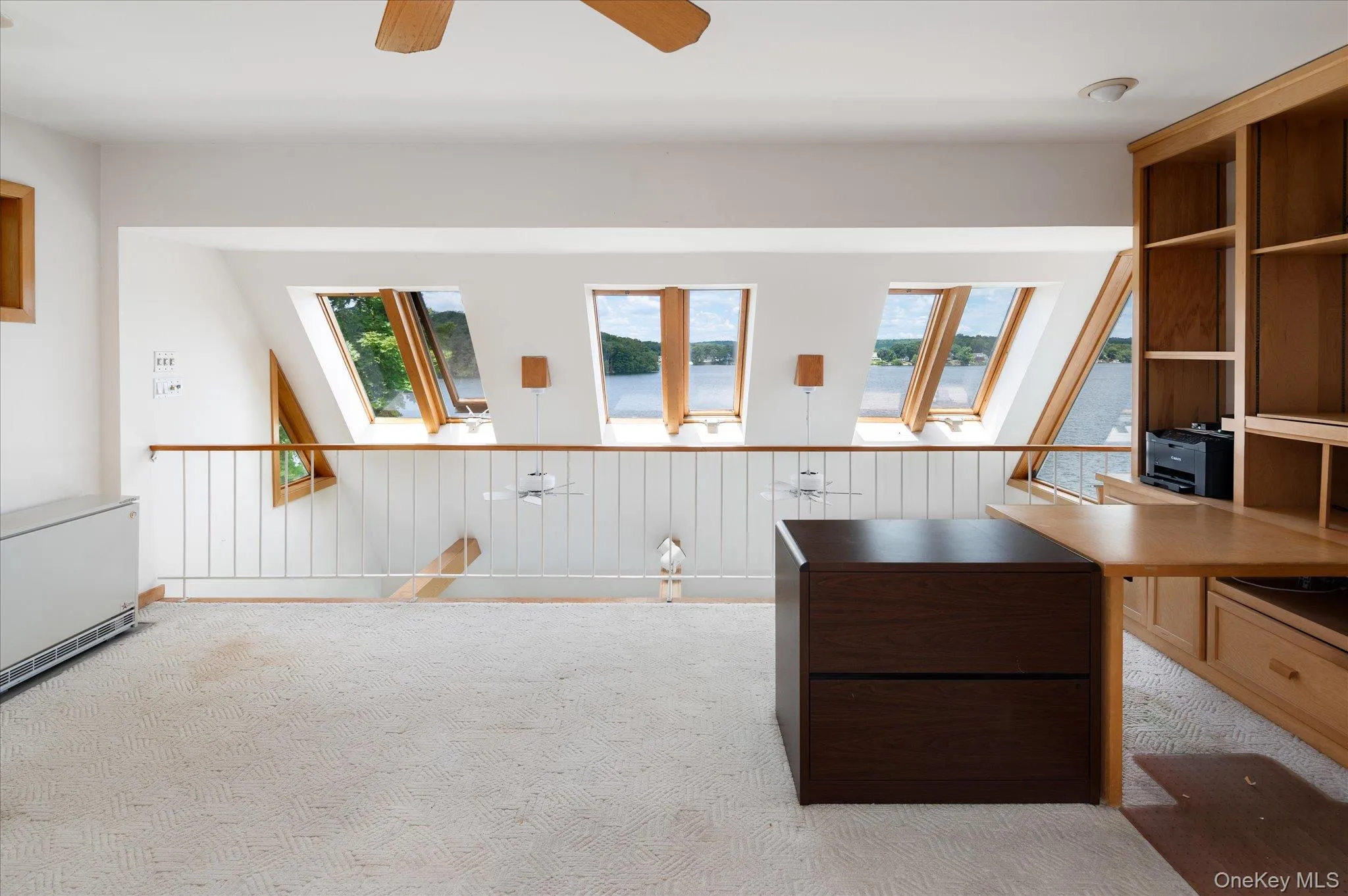 The bonus room is open to the main level below, drawing in lake views through sweeping sightlines The bonus room is open to the main level below, drawing in lake views through sweeping sightlines