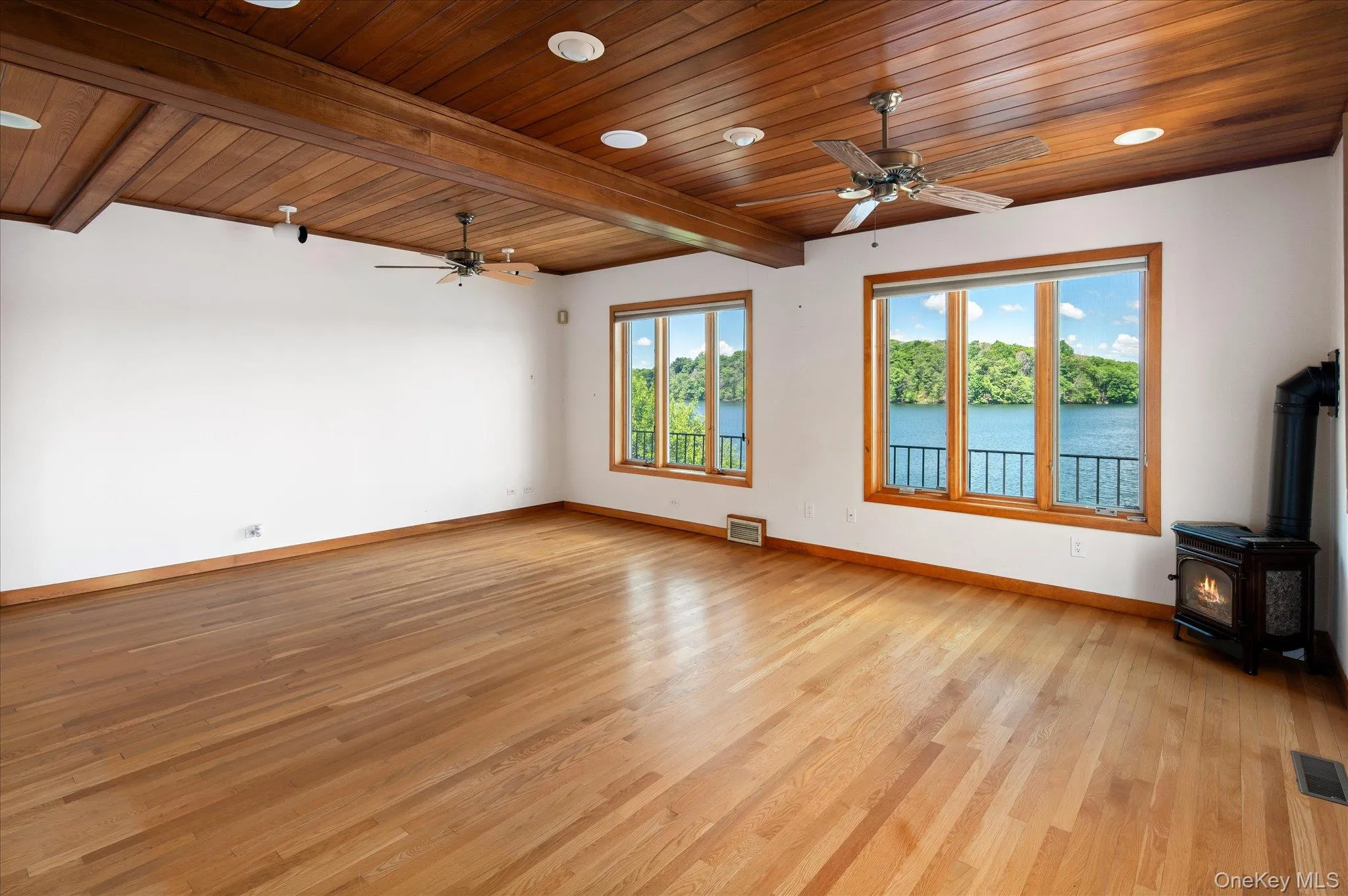 The main level primary suite with wood beamed ceiling and lake views on Lake Mahopac The main level primary suite with wood beamed ceiling and lake views on Lake Mahopac