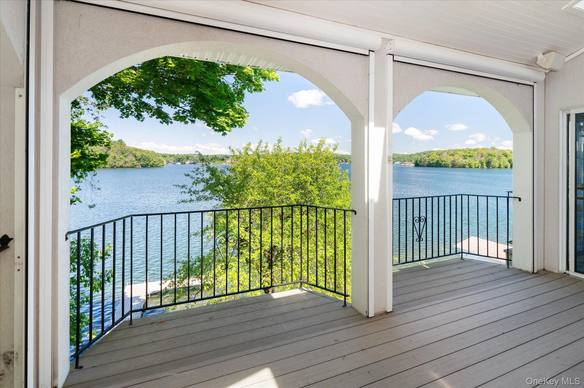 Graceful arched columns frame full views of Lake Mahopac from the indoor/outdoor living space Graceful arched columns frame full views of Lake Mahopac from the indoor/outdoor living space