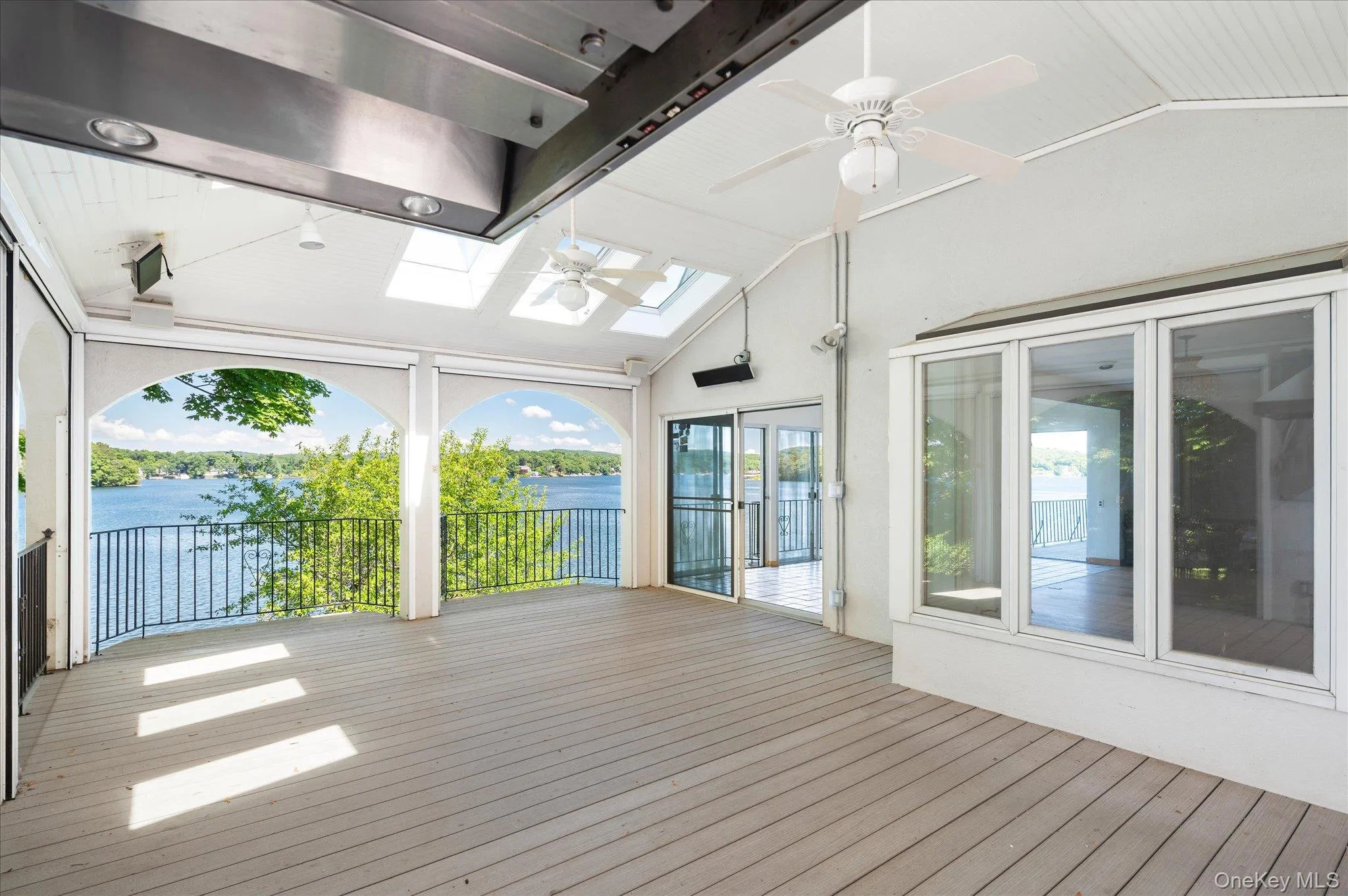 Motorized retractable screens disappear at the touch of a button, opening to Lake Mahopac Motorized retractable screens disappear at the touch of a button, opening to Lake Mahopac