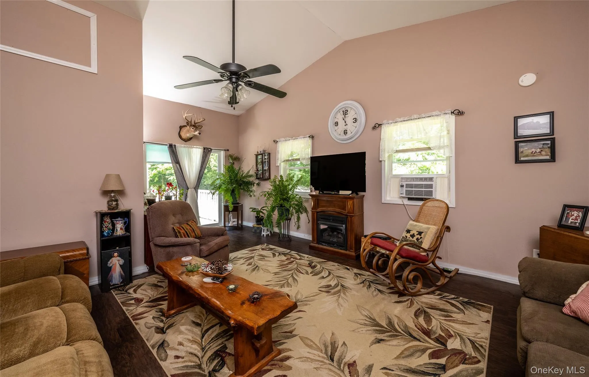 Spacious room with vaulted ceilings and ceiling fan Spacious room with vaulted ceilings and ceiling fan