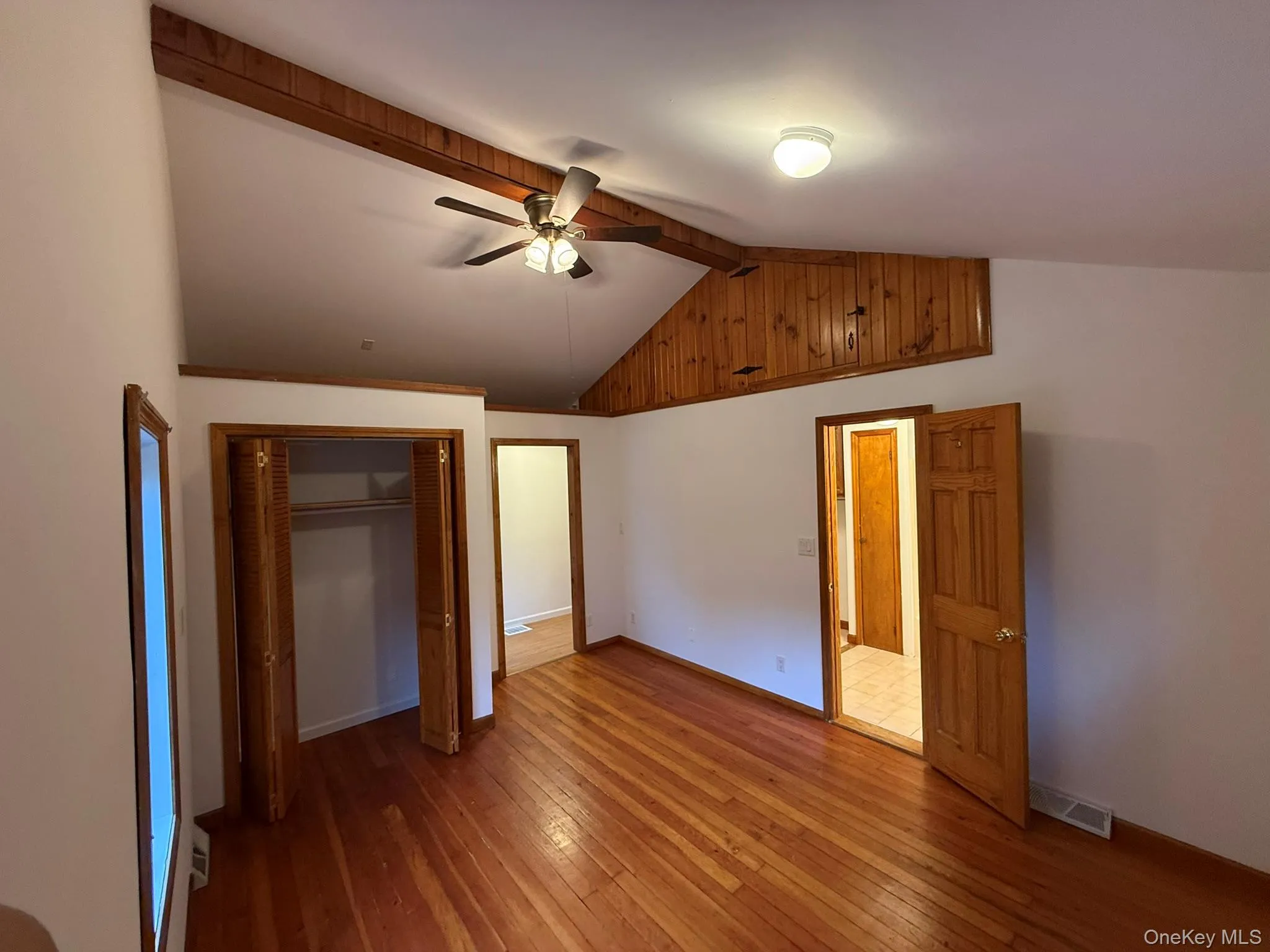 Bright and spacious primary bedroom with vaulted ceilings, a private ensuite bath, and ample storage Bright and spacious primary bedroom with vaulted ceilings, a private ensuite bath, and ample storage
