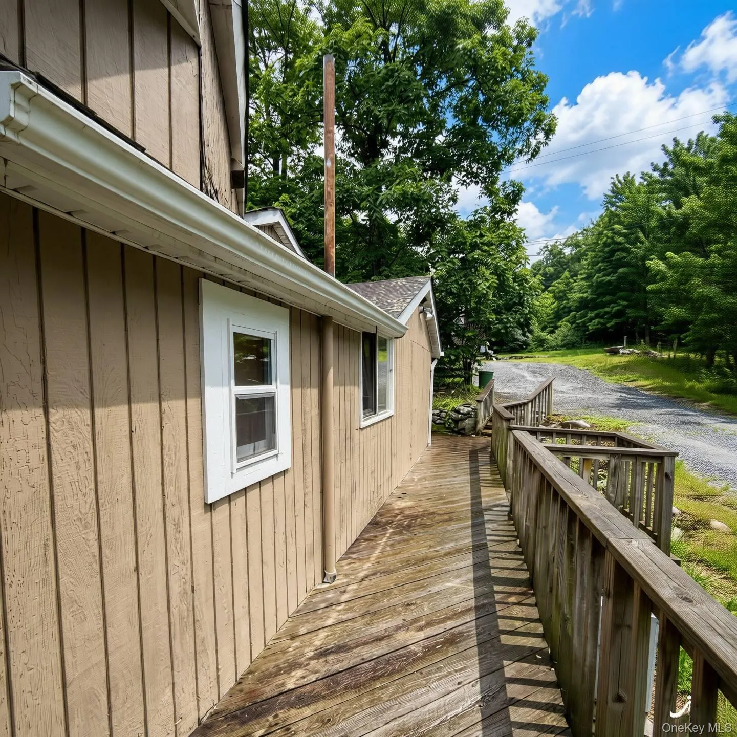 Side of deck leading from the back to the front of the house Side of deck leading from the back to the front of the house