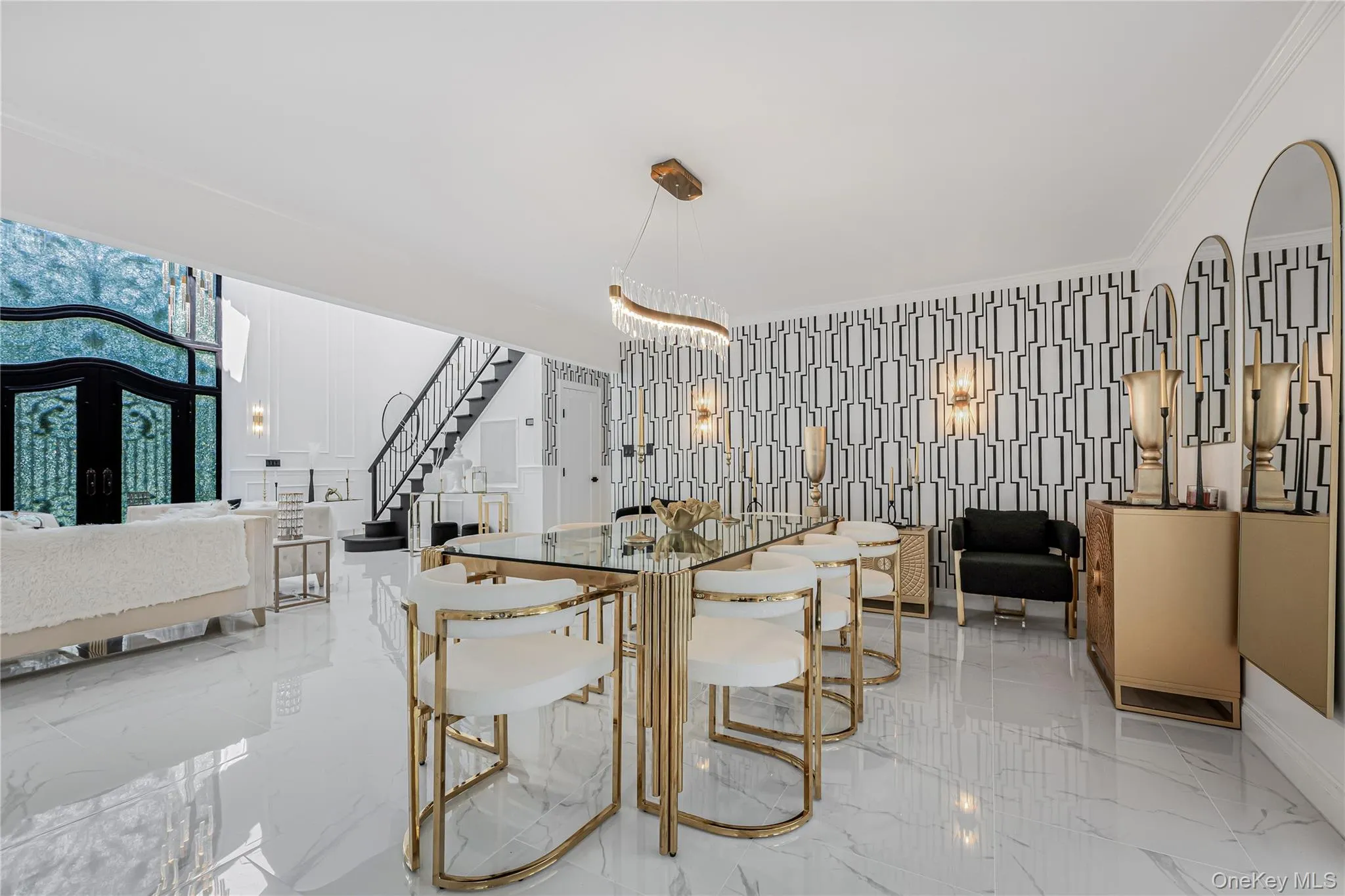 Dining room with stairway, light marble finish floors, ornamental molding, and french doors Dining room with stairway, light marble finish floors, ornamental molding, and french doors