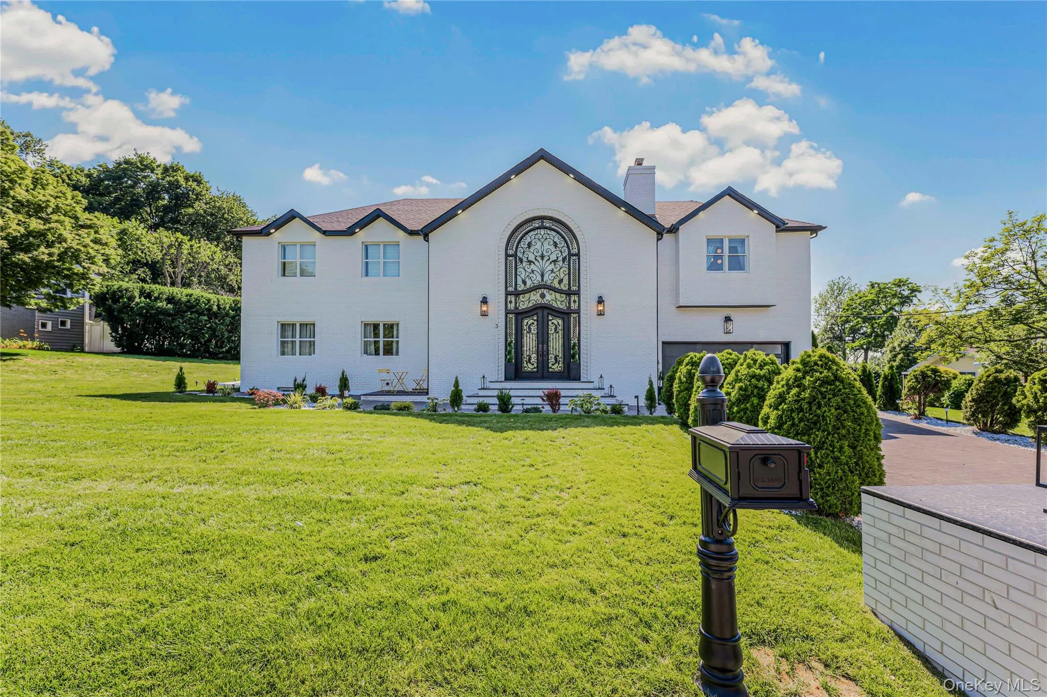 View of front of house with a chimney, an attached garage, french doors, and a front yard View of front of house with a chimney, an attached garage, french doors, and a front yard