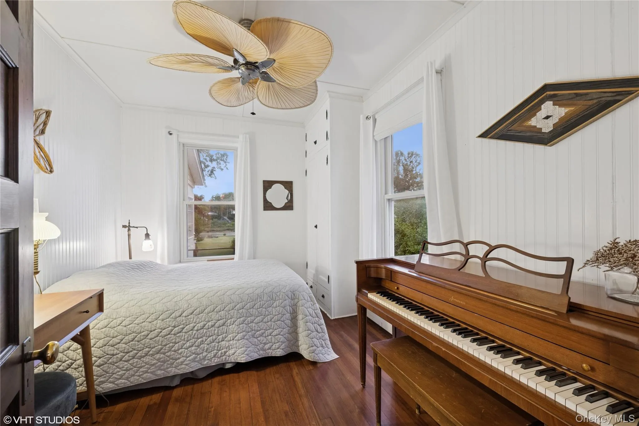 Bedroom featuring crown molding, multiple windows, dark wood finished floors, and ceiling fan Bedroom featuring crown molding, multiple windows, dark wood finished floors, and ceiling fan