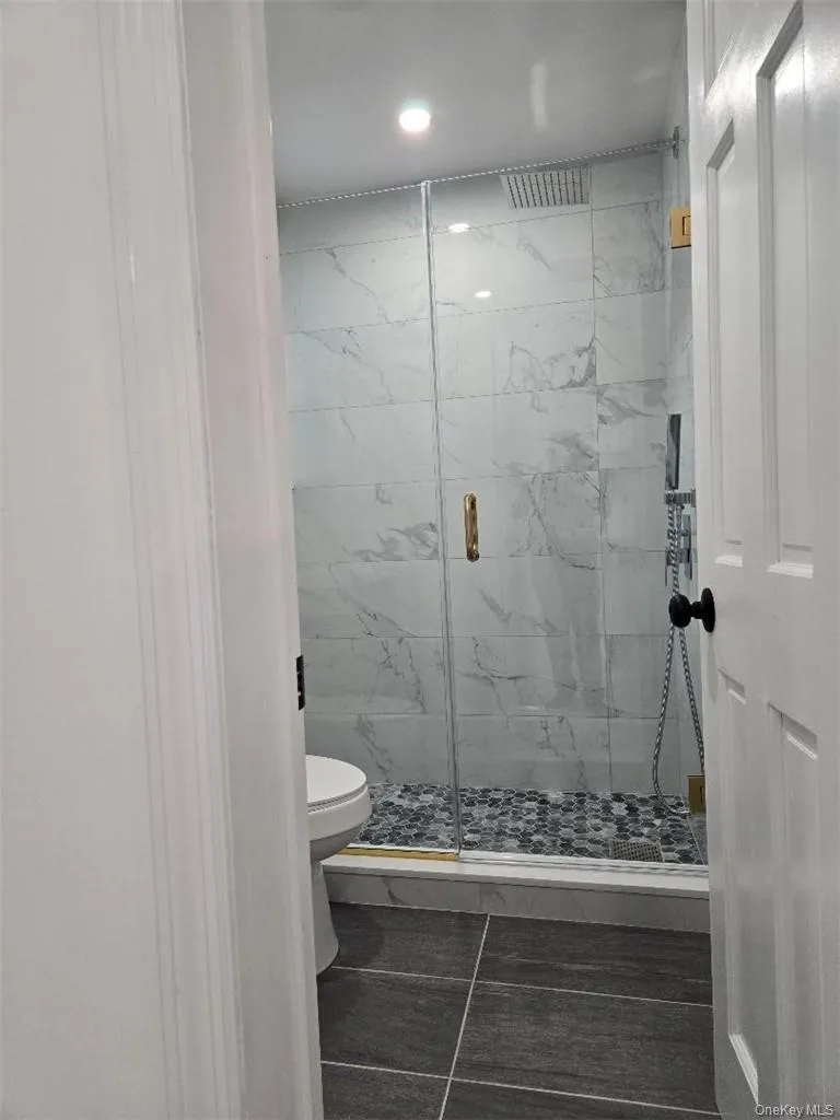 Entry to the Amazing, Upscale Bathroom with Sumptuous Tiling and Shower Stall and beautiful lighting. Entry to the Amazing, Upscale Bathroom with Sumptuous Tiling and Shower Stall and beautiful lighting.