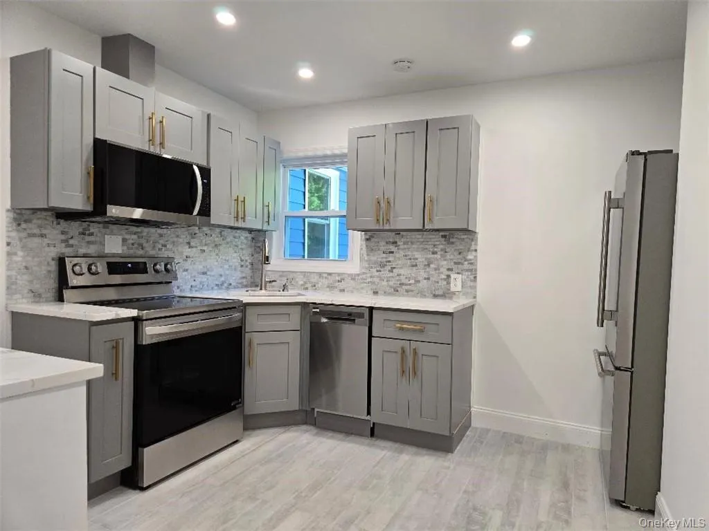 View of the Gorgeous, upscale Kitchen featuring quality cabinetry, Quartz Counter Tops, Stainless Steel Appliances and Recess Lighting! View of the Gorgeous, upscale Kitchen featuring quality cabinetry, Quartz Counter Tops, Stainless Steel Appliances and Recess Lighting!