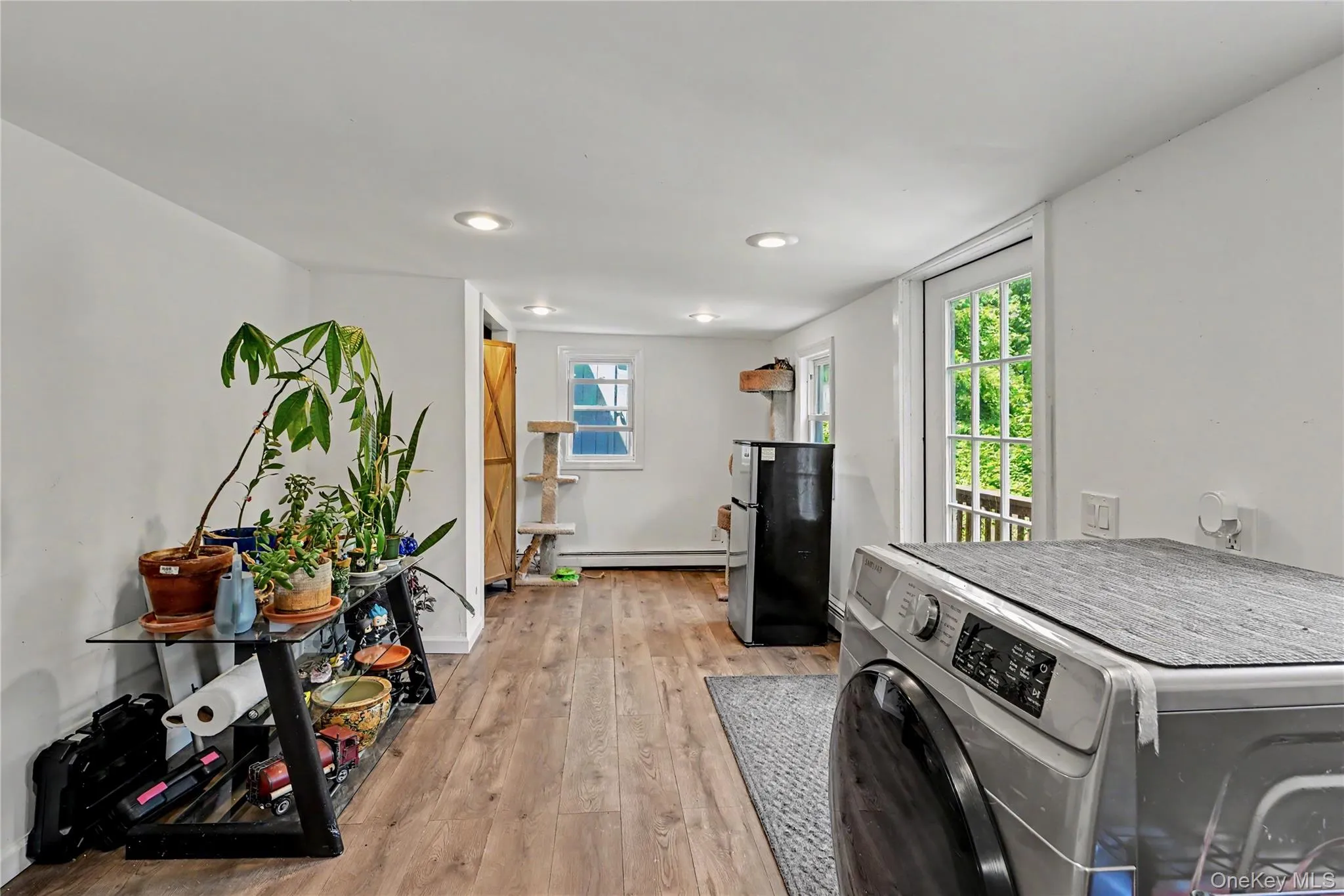 Flexible room space featuring wood-finish tiled flooring, recessed lighting and door to deck and backyard. Flexible room space featuring wood-finish tiled flooring, recessed lighting and door to deck and backyard.