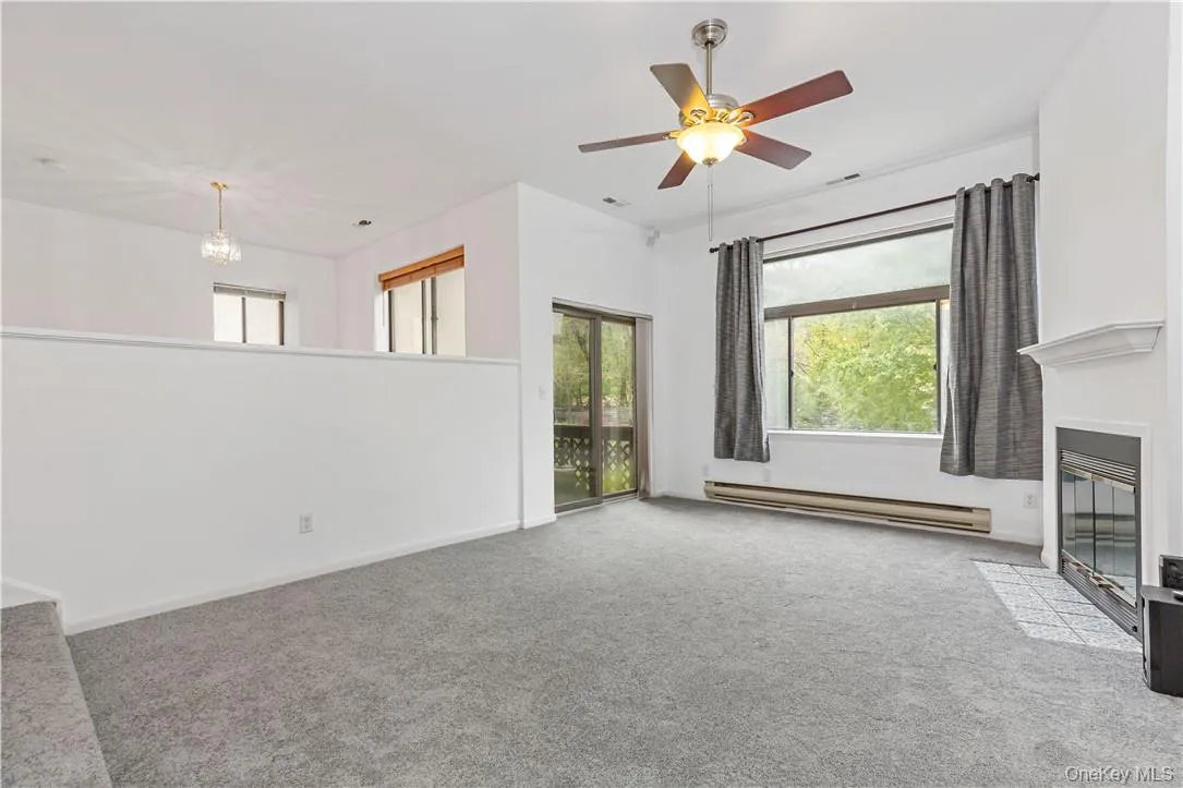 Step down Living Rood with fireplace and doors out to balcony Step down Living Rood with fireplace and doors out to balcony