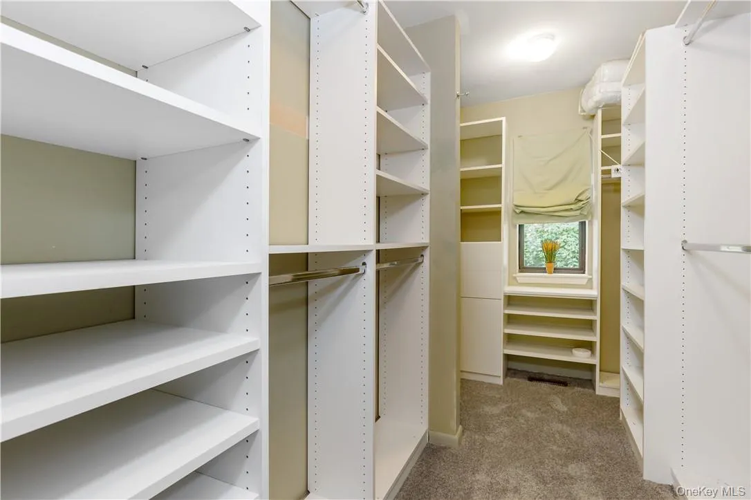 Primary Bedroom Closet with built-ins Primary Bedroom Closet with built-ins