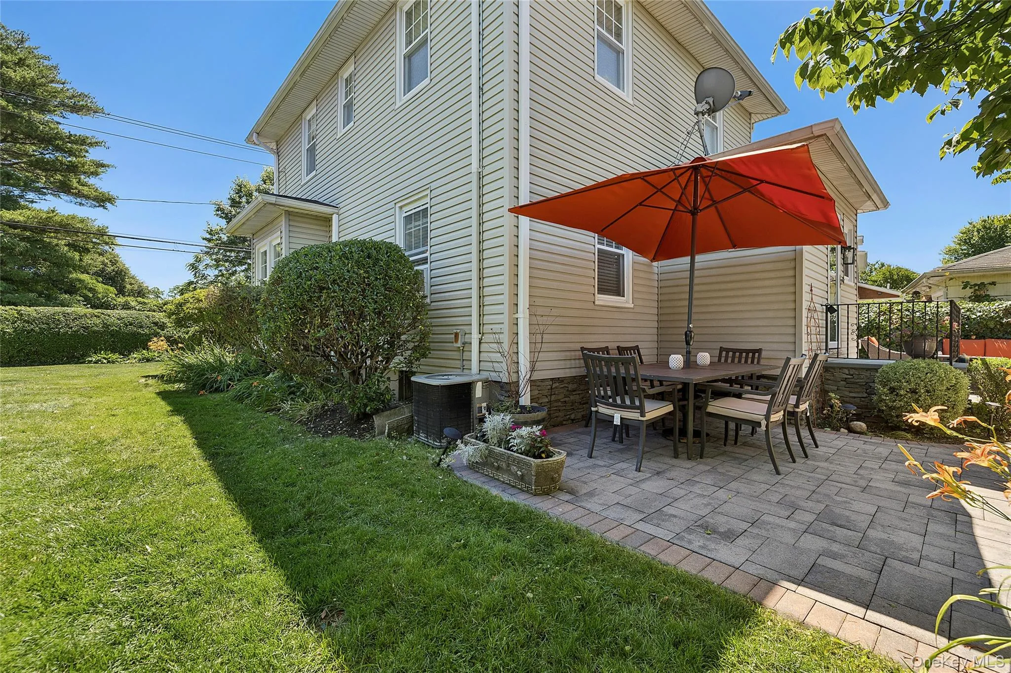 Side yard and paver patio in back of house Side yard and paver patio in back of house