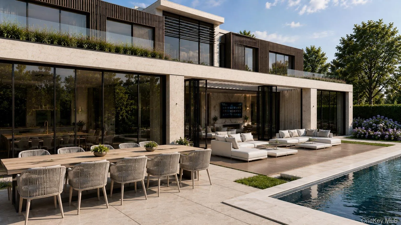 Contemporary residence featuring a rectangular swimming pool, an expansive patio, and retractable glass doors opening to an outdoor lounge area Contemporary residence featuring a rectangular swimming pool, an expansive patio, and retractable glass doors opening to an outdoor lounge area