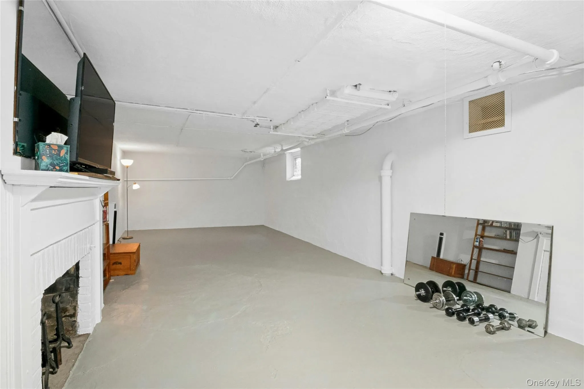 Spacious lower level with neutral flooring and white walls Spacious lower level with neutral flooring and white walls