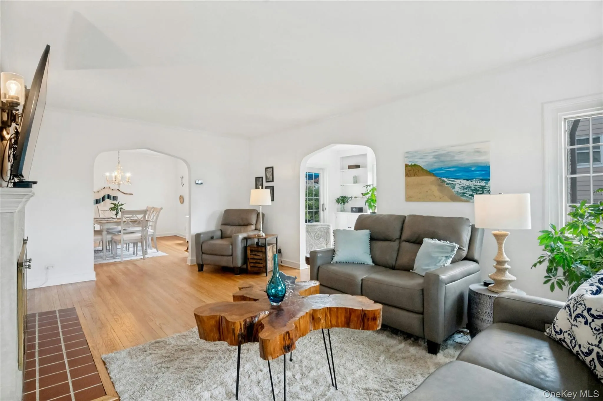 Living area featuring hardwood flooring and arched doorways Living area featuring hardwood flooring and arched doorways