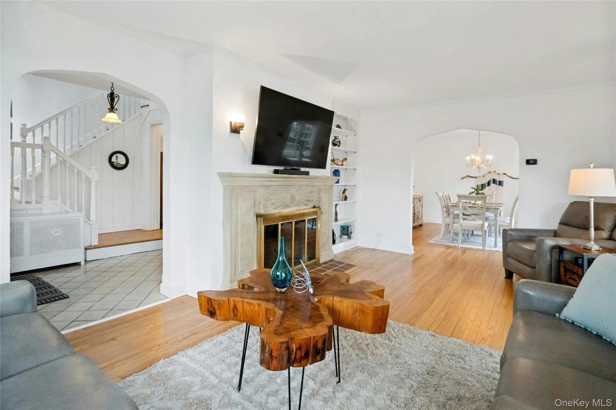 Living area featuring wood-finish flooring and a decorative fireplace with an ornate mantel Living area featuring wood-finish flooring and a decorative fireplace with an ornate mantel
