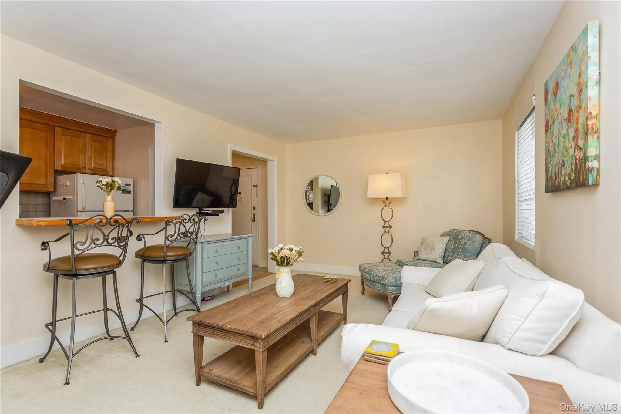 Living area featuring light colored carpet Living area featuring light colored carpet