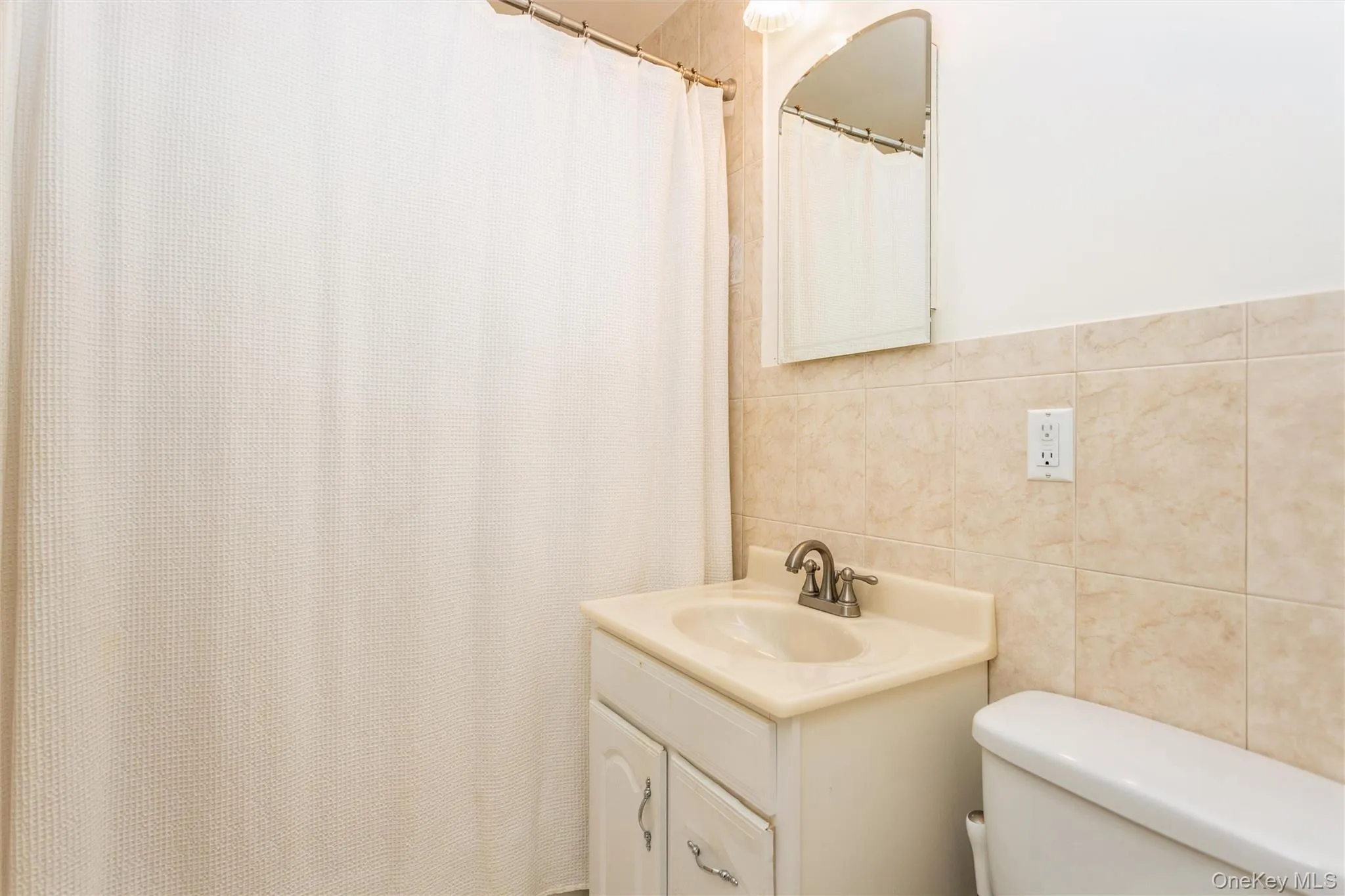 Full bathroom featuring tile walls, vanity Full bathroom featuring tile walls, vanity