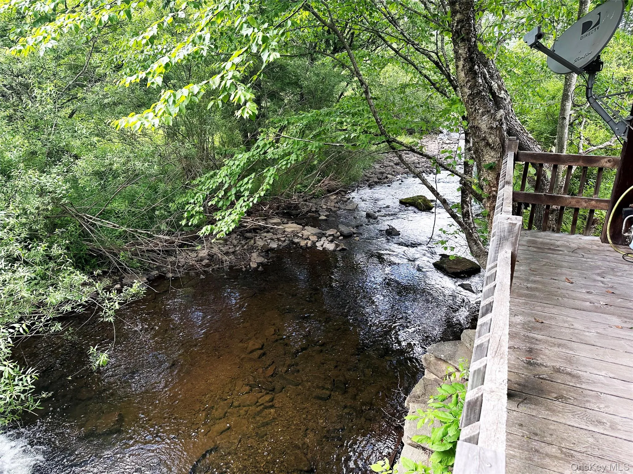 Covered porch overlooking Trout Brook, offering a rare opportunity to relax, entertain, or fish directly from the property. Covered porch overlooking Trout Brook, offering a rare opportunity to relax, entertain, or fish directly from the property.