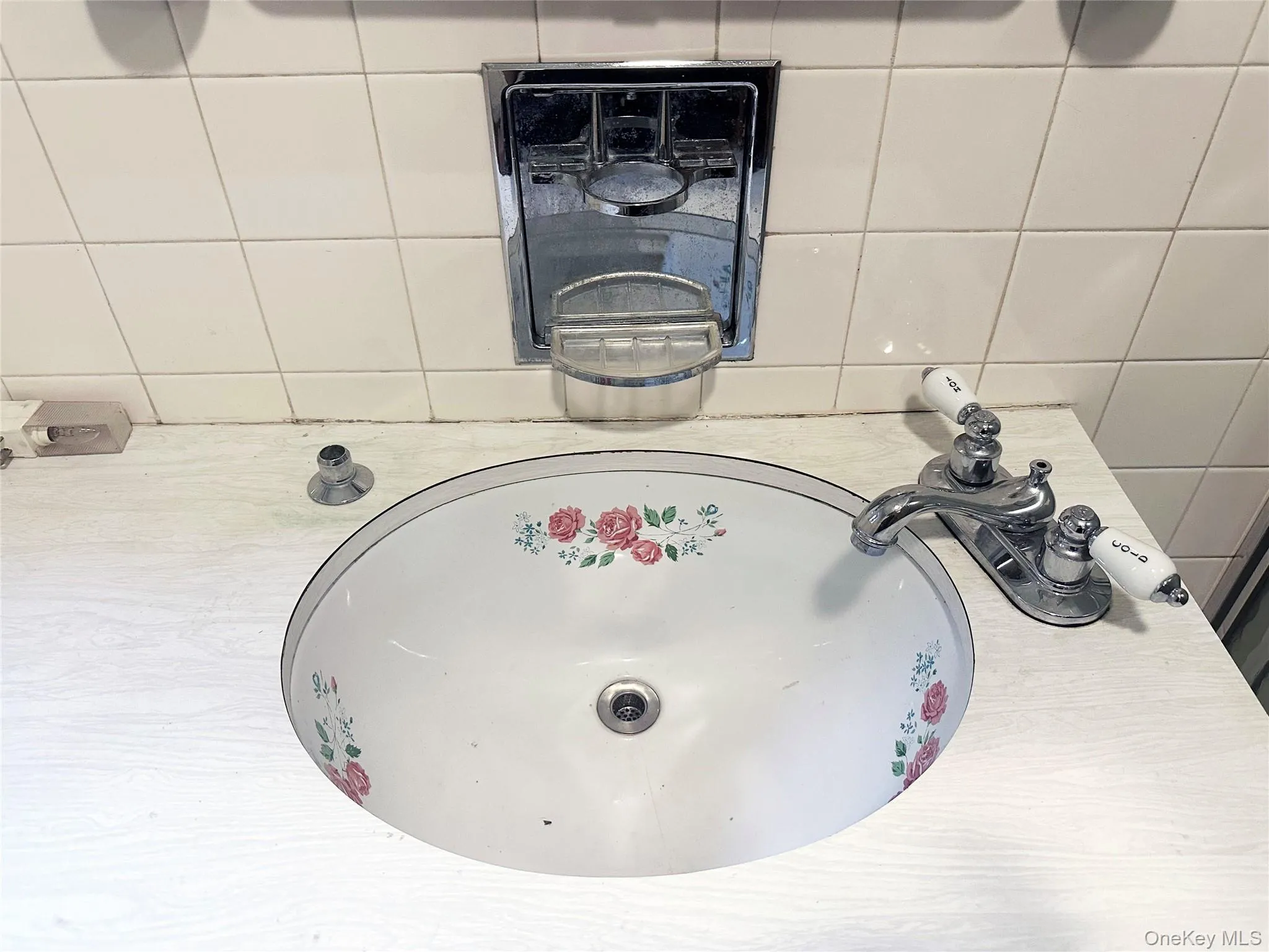 Vintage floral sink detail preserving the home’s original character and mid-century charm. Vintage floral sink detail preserving the home’s original character and mid-century charm.